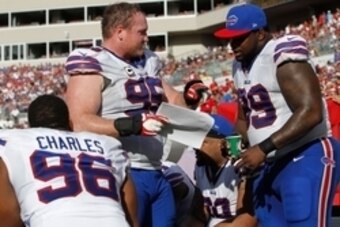 Dec 8, 2013; Tampa, FL, USA; Buffalo Bills defensive tackle Kyle Williams (95) and defensive tackle Marcell Dareus (99) talk on the bench against the Tampa Bay Buccaneers during the second half at Raymond James Stadium. Tampa Bay Buccaneers defeated the B