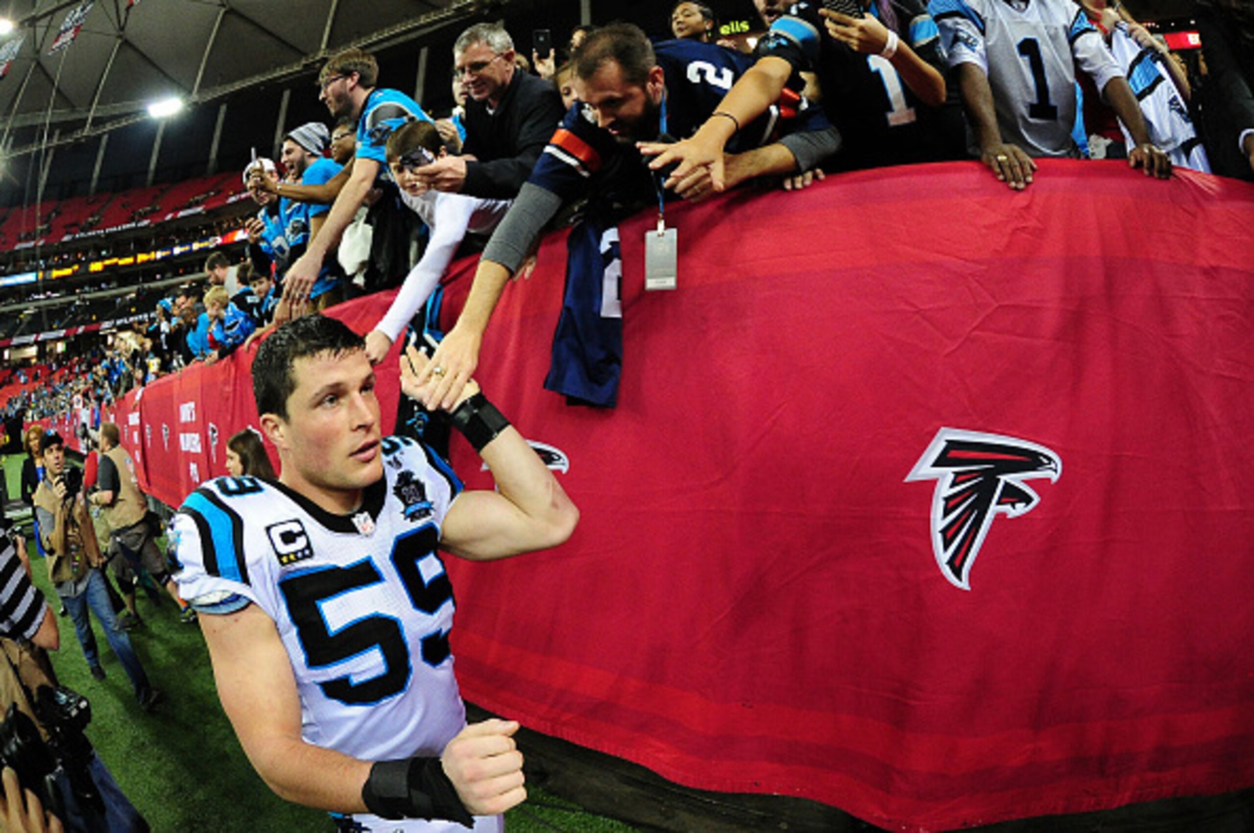ATLANTA, GA - DECEMBER 28: Luke Kuechly #59 of the Carolina Panthers celebrates with fans after the game against the Atlanta Falcons at the Georgia Dome on December 28, 2014 in Atlanta, Georgia.  (Photo by Scott Cunningham/Getty Images)