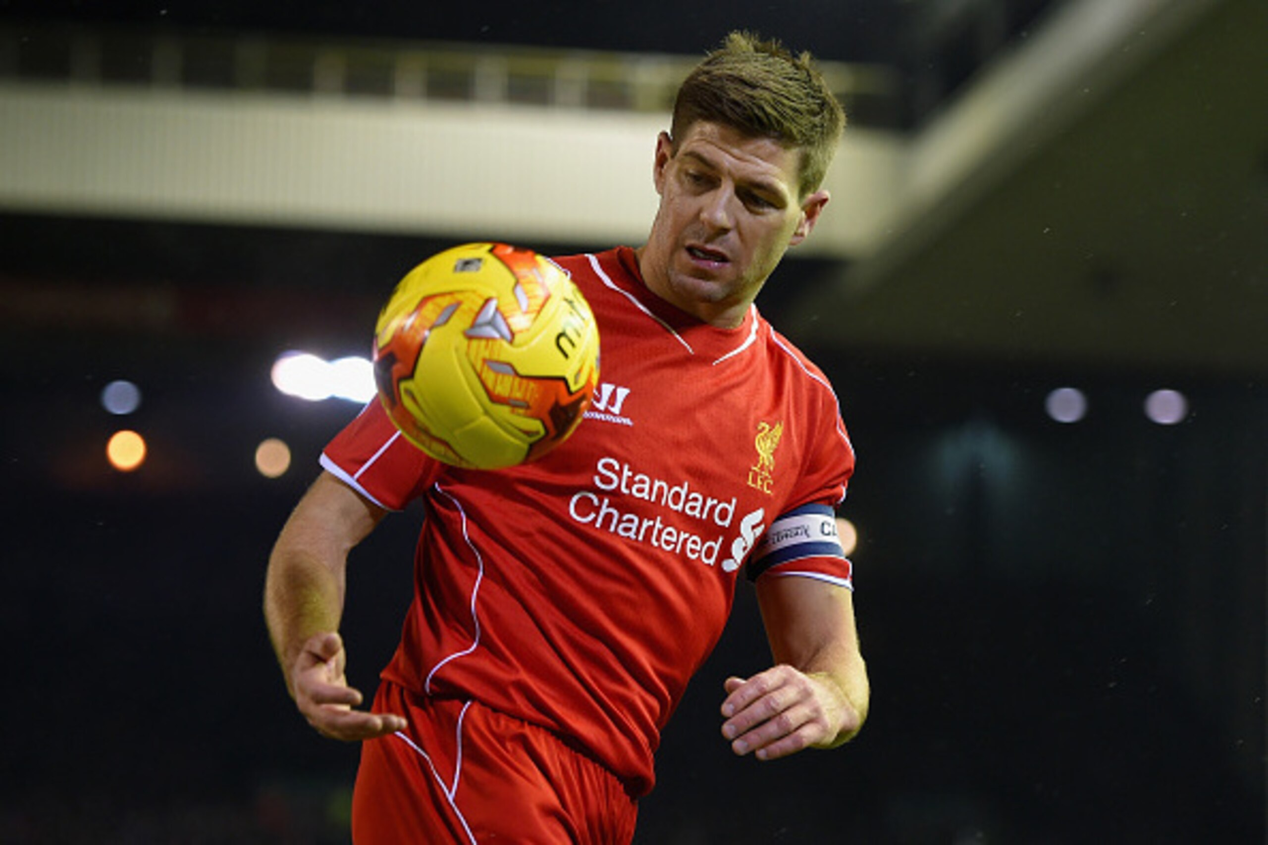 LIVERPOOL, ENGLAND - JANUARY 20:  Steven Gerrard of Liverpool collects the ball during the Capital One Cup Semi-Final first leg match between Liverpool and Chelsea at Anfield on January 20, 2015 in Liverpool, England.  (Photo by Michael Regan/Getty Images