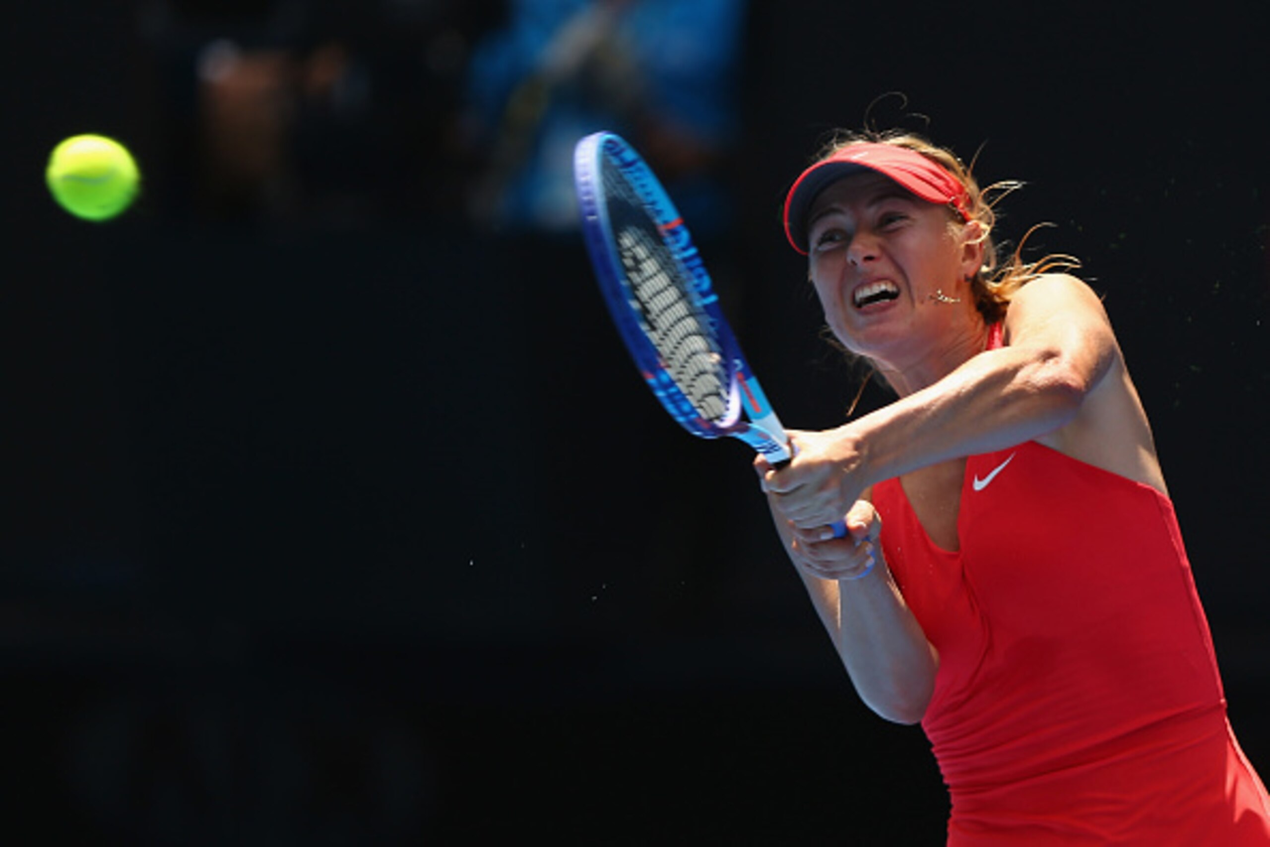 MELBOURNE, AUSTRALIA - JANUARY 21:  Maria Sharapova of Russia plays a backhand in her second round match against Alexandra Panova of Russia during day three of the 2015 Australian Open at Melbourne Park on January 21, 2015 in Melbourne, Australia.  (Photo