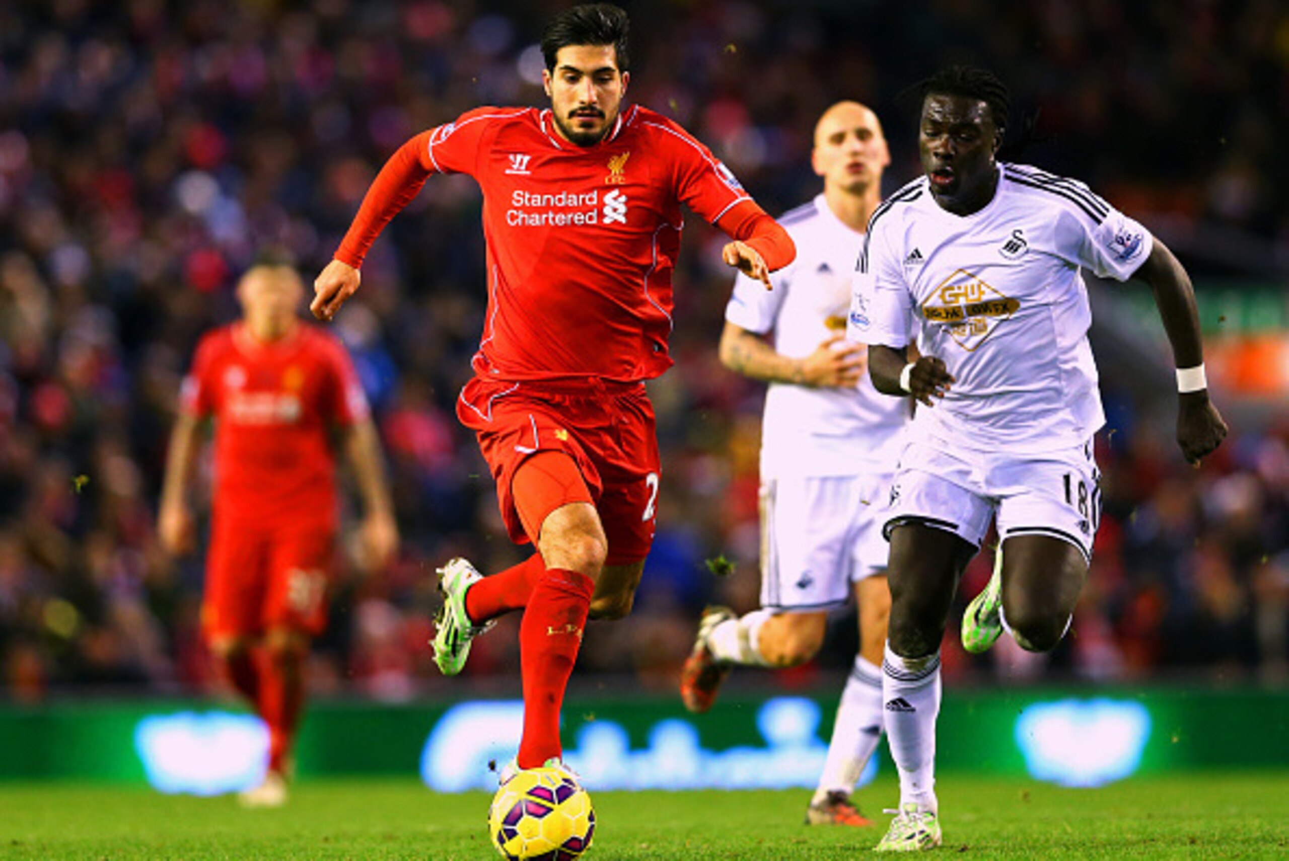 LIVERPOOL, ENGLAND - DECEMBER 29:  Emre Can of Liverpool battles for the ball with Bafetibis Gomis of Swansea City during the Barclays Premier League match between Liverpool and Swansea City at Anfield on December 29, 2014 in Liverpool, England.  (Photo b
