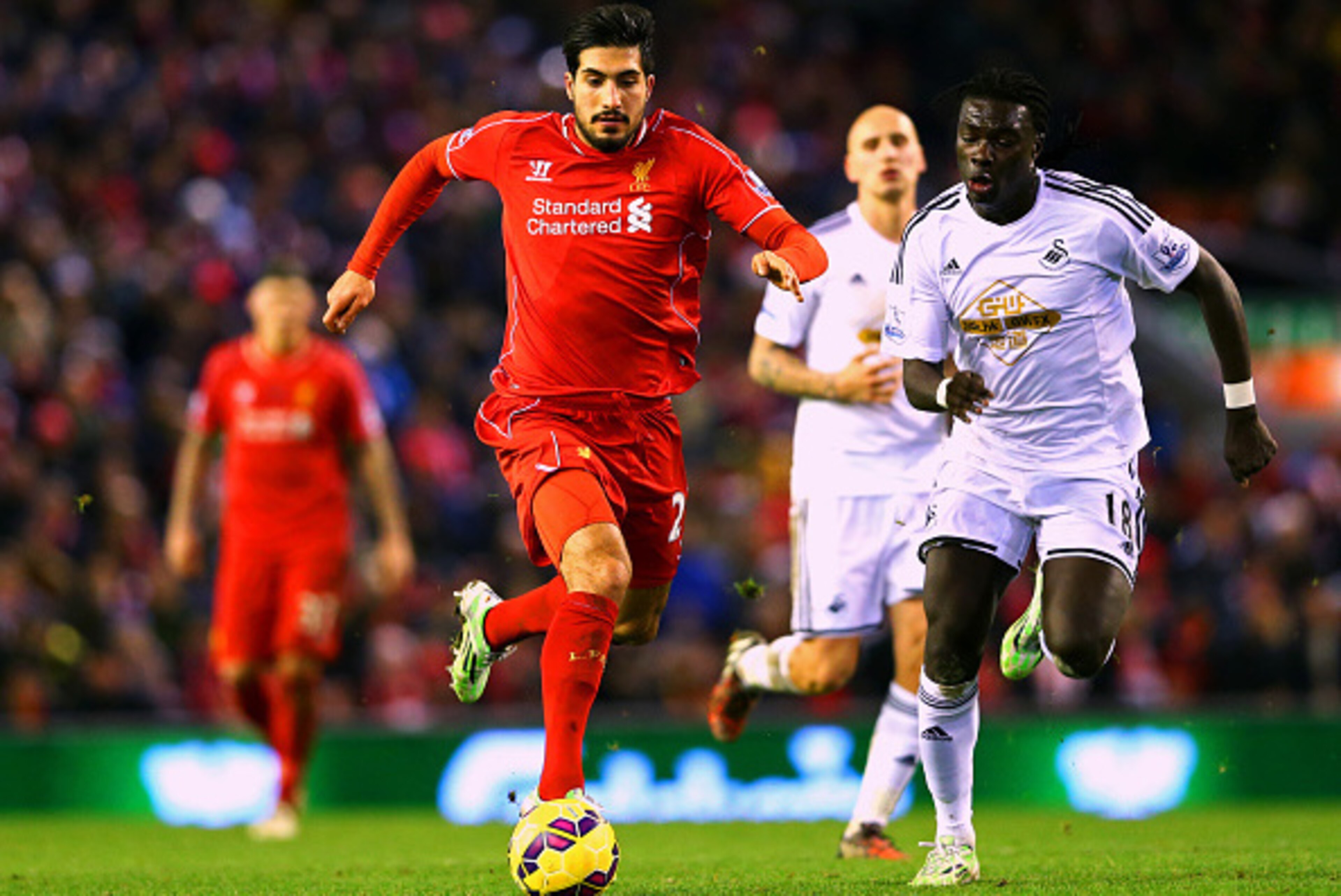 LIVERPOOL, ENGLAND - DECEMBER 29:  Emre Can of Liverpool battles for the ball with Bafetibis Gomis of Swansea City during the Barclays Premier League match between Liverpool and Swansea City at Anfield on December 29, 2014 in Liverpool, England.  (Photo b