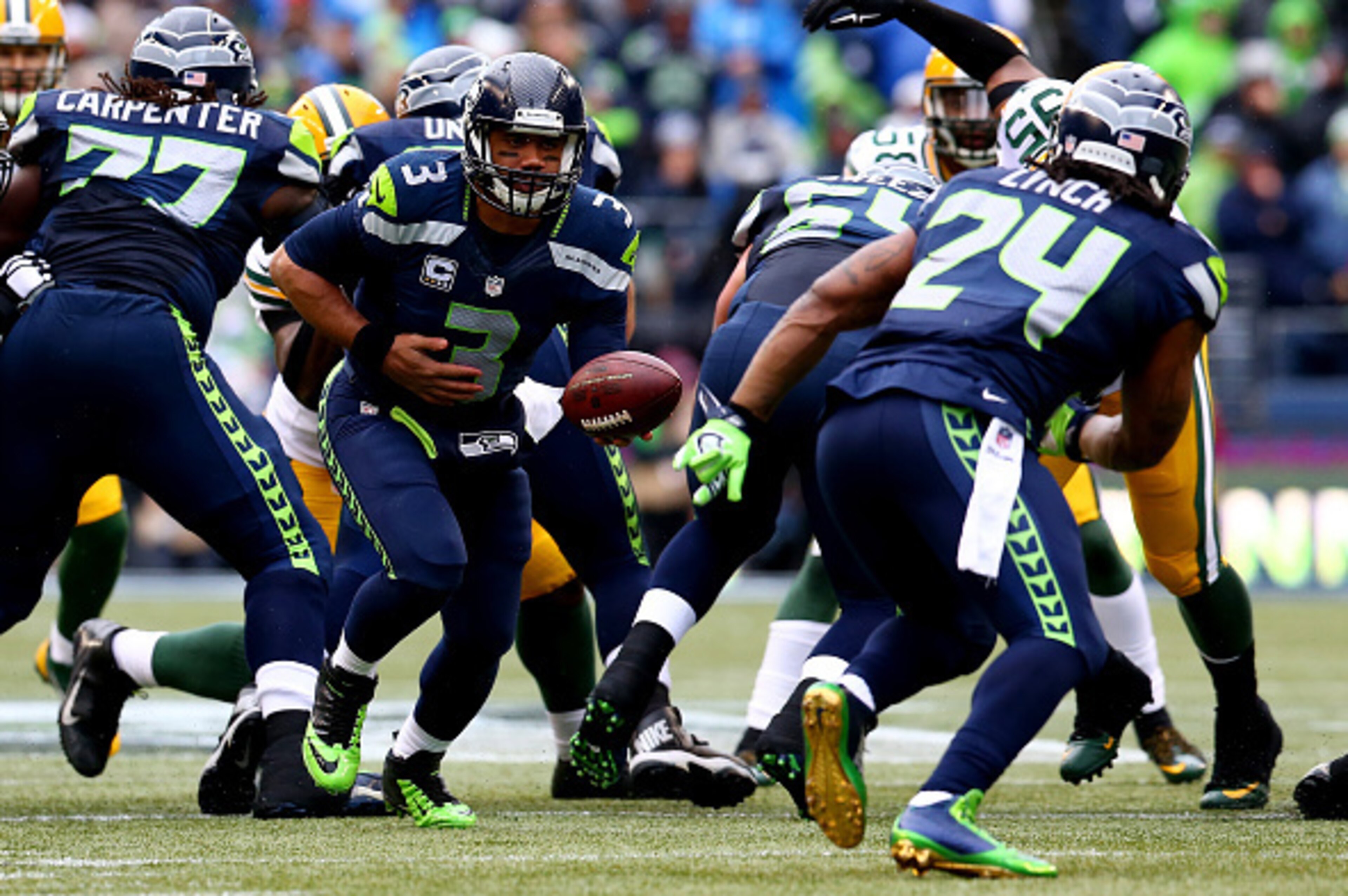 SEATTLE, WA - JANUARY 18:  Russell Wilson #3 drops back to hand the ball off to Marshawn Lynch #24 of the Seattle Seahawks against the Green Bay Packers during the 2015 NFC Championship game at CenturyLink Field on January 18, 2015 in Seattle, Washington.