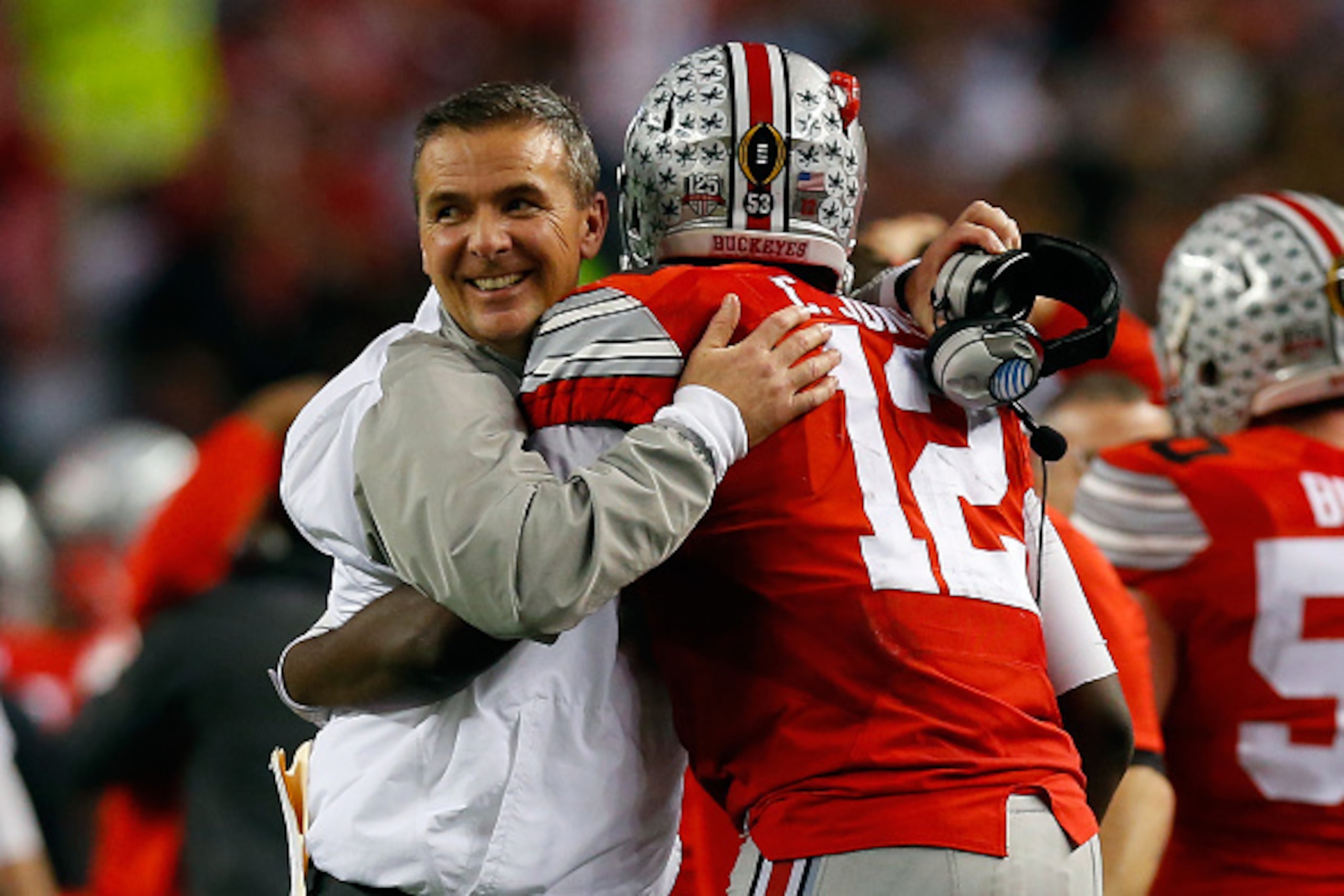 ARLINGTON, TX - JANUARY 12:  Head Coach Urban Meyer of the Ohio State Buckeyes hugs Quarterback Cardale Jones #12 in the fourth quarter against the Oregon Ducks during the College Football Playoff National Championship Game at AT&T Stadium on January 12, 