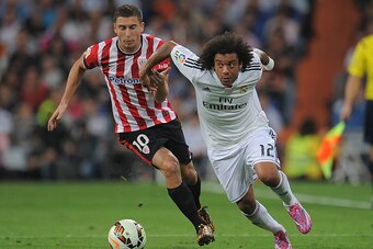 MADRID, SPAIN - OCTOBER 05:  Oscar de Marcos of Club Athletic tries to hold back Marcelo of Real Madrid during the La Liga match between Real Madrid CF and Athletic Club at Estadio Santiago Bernabeu on October 5, 2014 in Madrid, Spain.  (Photo by Denis Do