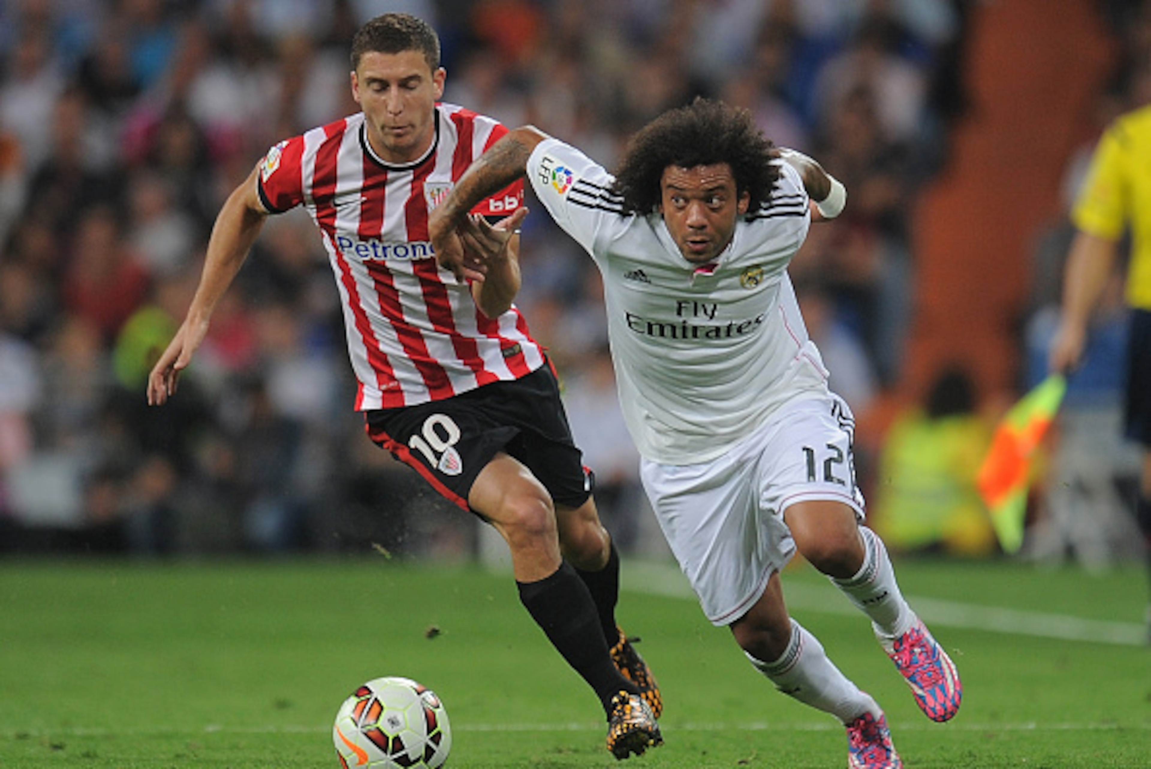 MADRID, SPAIN - OCTOBER 05:  Oscar de Marcos of Club Athletic tries to hold back Marcelo of Real Madrid during the La Liga match between Real Madrid CF and Athletic Club at Estadio Santiago Bernabeu on October 5, 2014 in Madrid, Spain.  (Photo by Denis Do