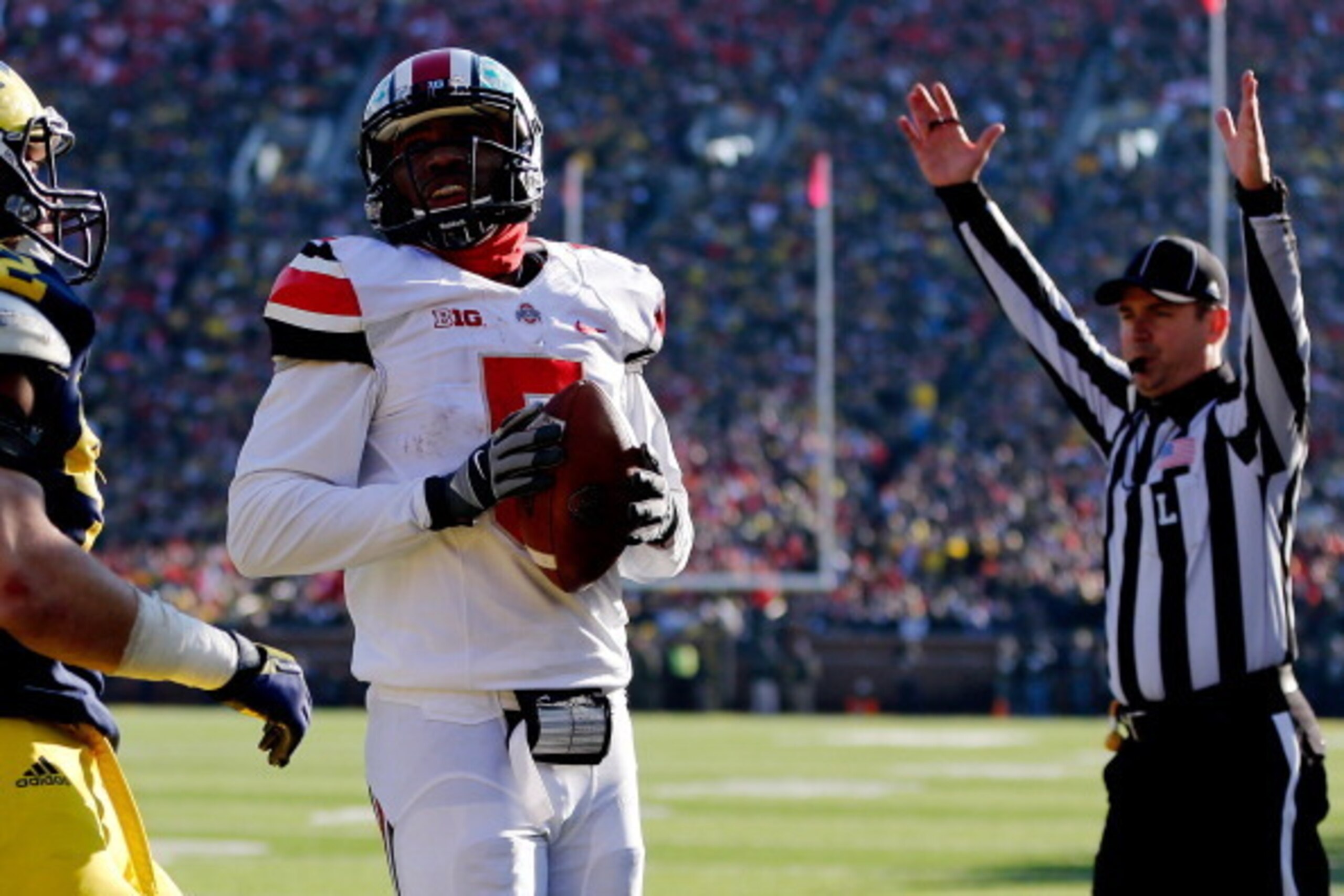 ANN ARBOR, MI - NOVEMBER 30:  Quarterback Braxton Miller #5 of the Ohio State Buckeyes scores a touchdown in the third quarter against the Michigan Wolverines during a game at Michigan Stadium on November 30, 2013 in Ann Arbor, Michigan.  (Photo by Gregor