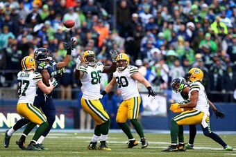 SEATTLE, WA - JANUARY 18: Brandon Bostick #86 of the Green Bay Packers bobbles an onsides kick as Chris Matthews #13 of the Seattle Seahawks and Jordy Nelson #87 of the Green Bay Packers close in during the fourth quarter of the 2015 NFC Championship game