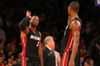Nov 30, 2014; New York, NY, USA; Miami Heat guard Dwyane Wade (3) and center Chris Bosh (1) celebrate against the New York Knicks during the fourth quarter at Madison Square Garden. The Heat defeated the Knicks 86-79. Mandatory Credit: Adam Hunger-USA TOD