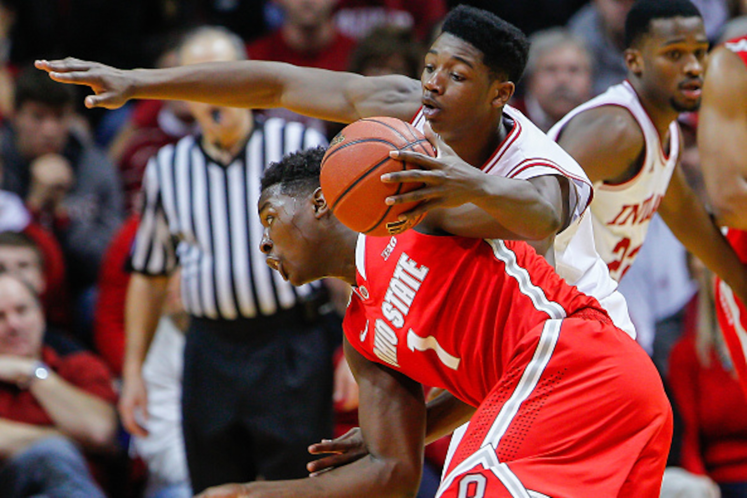 BLOOMINGTON, IN - JANUARY 10: Jae'Sean Tate #1 of the Ohio State Buckeyes dribbles the ball as Emmitt Holt #25 of the Indiana Hoosiers defends from up top at Assembly Hall on January 10, 2015 in Bloomington, Indiana. Indiana defeated Ohio State 69-66. (Ph
