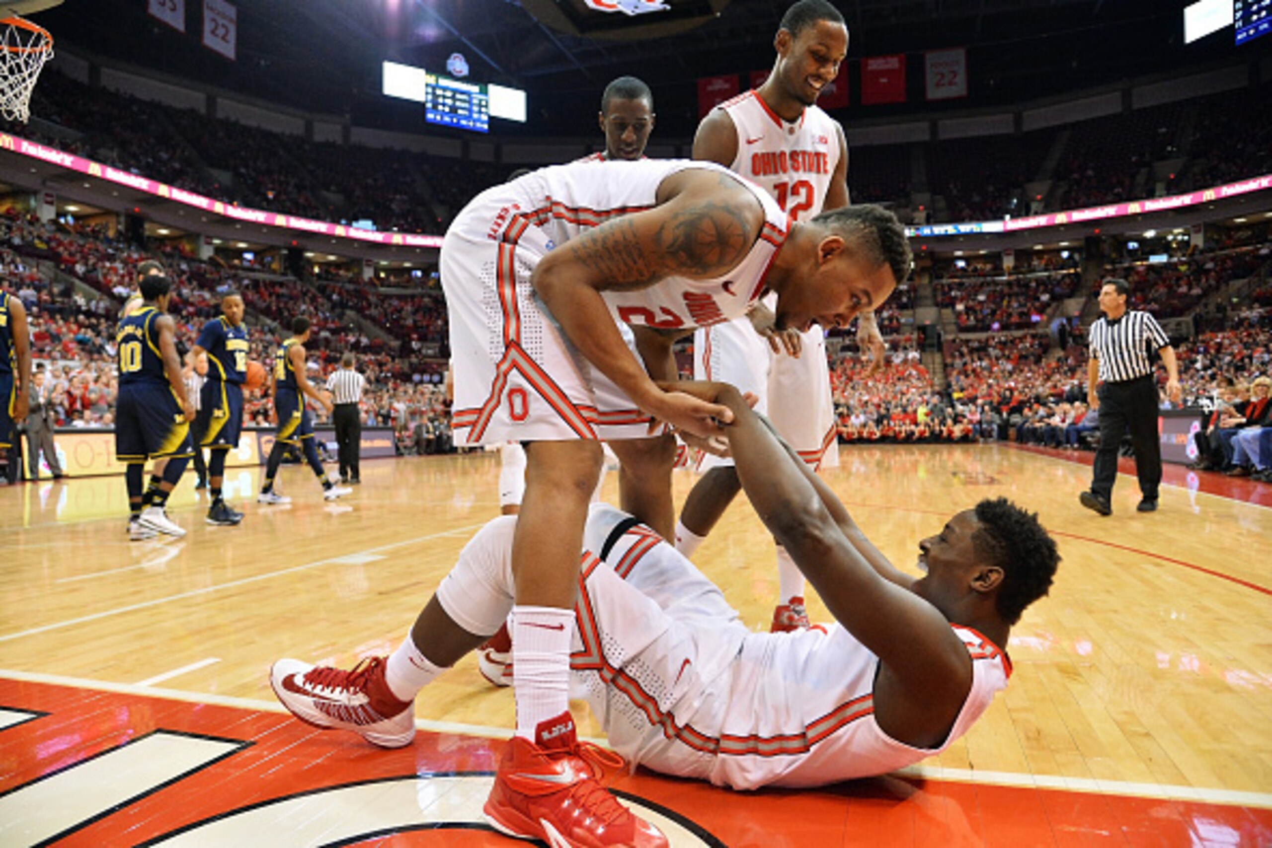 COLUMBUS, OH - JANUARY 13:  Amir Williams #23 of the Ohio State Buckeyes celebrates with Jae'Sean Tate #1 of the Ohio State Buckeyes after Tate's hustle kept the ball inbounds and drew a foul in the second half against the Michigan Wolverines on January 1