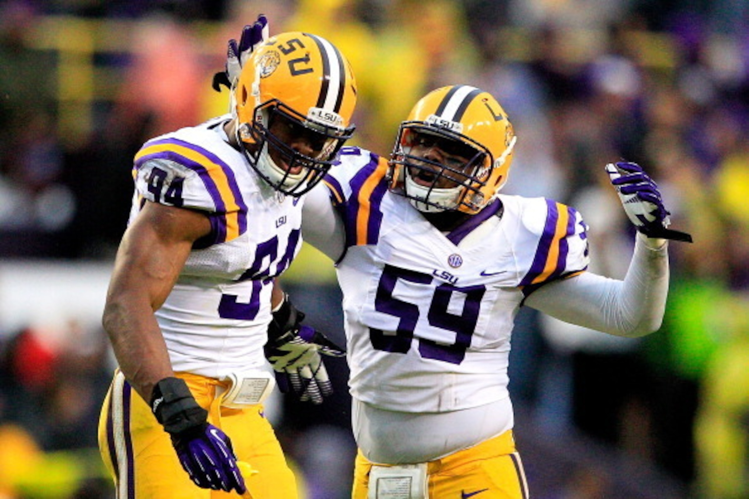 BATON ROUGE, LA - NOVEMBER 23:  Defensive end Danielle Hunter #94 of the LSU Tigers celebrates with his teammate defensive end Jermauria Rasco #59 after sacking quarterback  Johnny Manziel #2 of the Texas A&M Aggies at Tiger Stadium on November 23, 2013 i