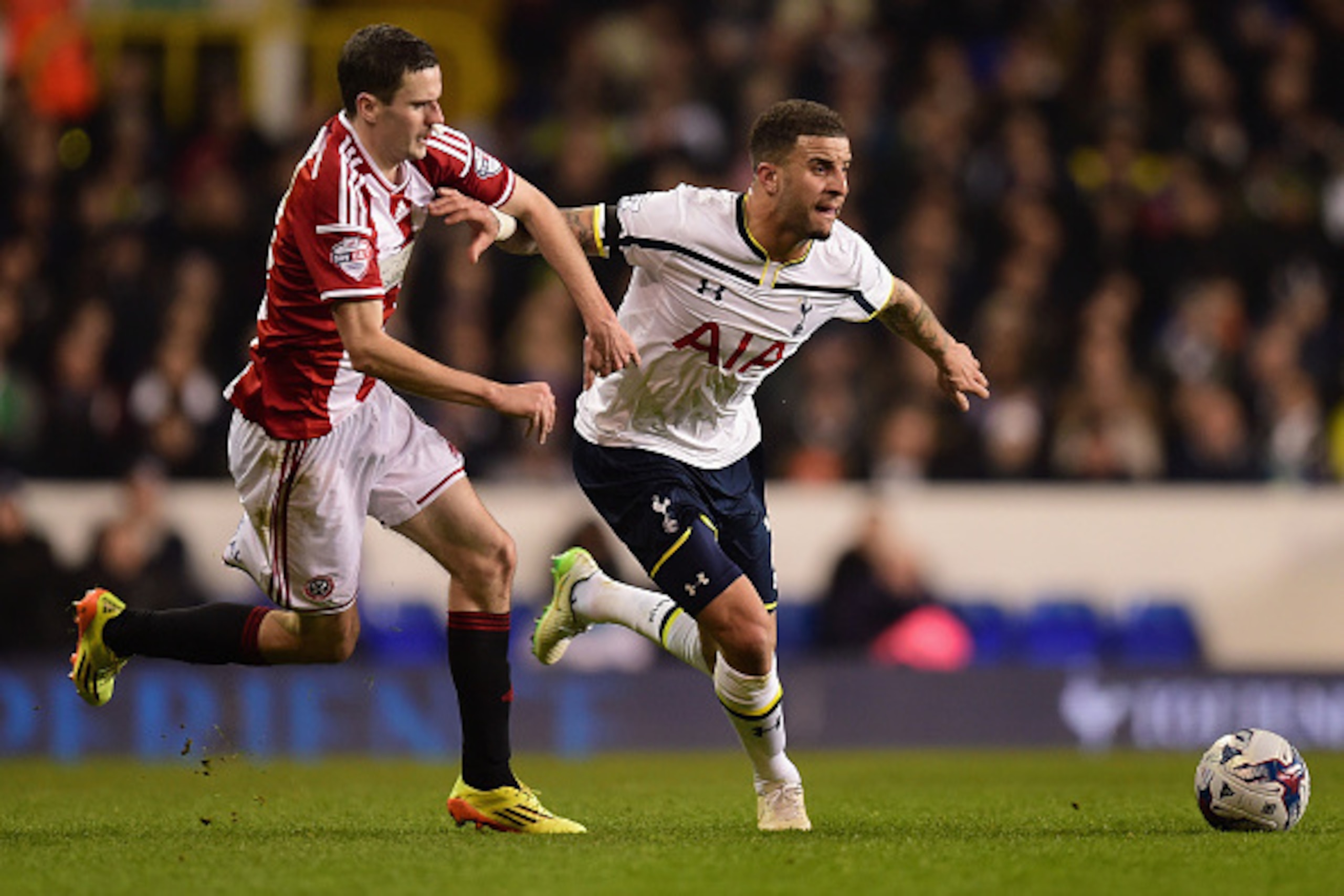 LONDON, ENGLAND - JANUARY 21:  Kyle Walker of Spurs holds off a challenge from Jamie Murphy of Sheffield United during the Capital One Cup Semi-Final first leg match between Tottenham Hotspur and Sheffield United at White Hart Lane on January 21, 2015 in 