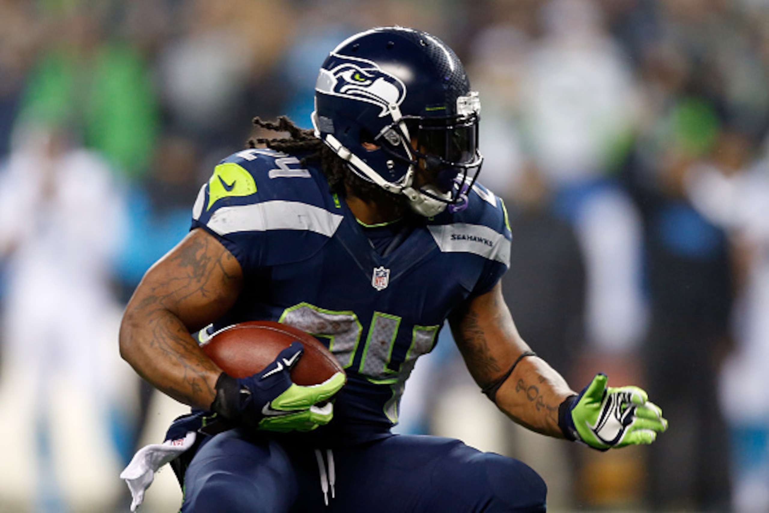 SEATTLE, WA - JANUARY 10:  Marshawn Lynch #24 of the Seattle Seahawks runs the ball against the Carolina Panthers during the 2015 NFC Divisional Playoff game at CenturyLink Field on January 10, 2015 in Seattle, Washington.  (Photo by Otto Greule Jr/Getty 