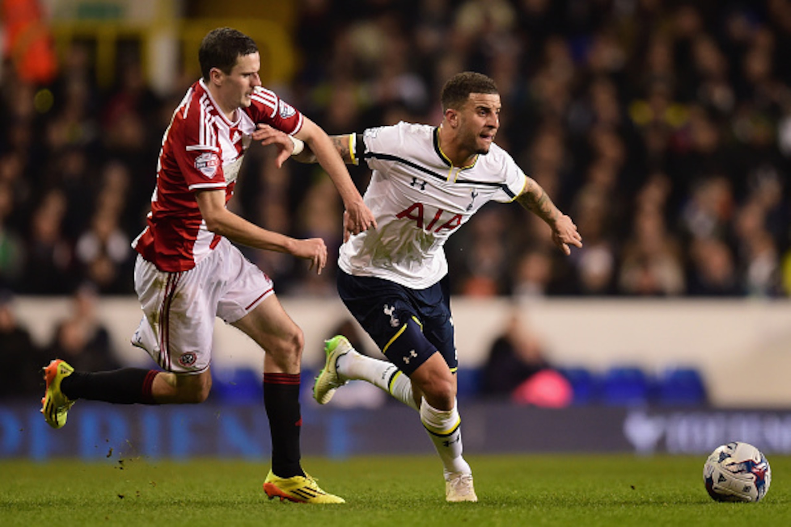 LONDON, ENGLAND - JANUARY 21:  Kyle Walker of Spurs holds off a challenge from Jamie Murphy of Sheffield United during the Capital One Cup Semi-Final first leg match between Tottenham Hotspur and Sheffield United at White Hart Lane on January 21, 2015 in 