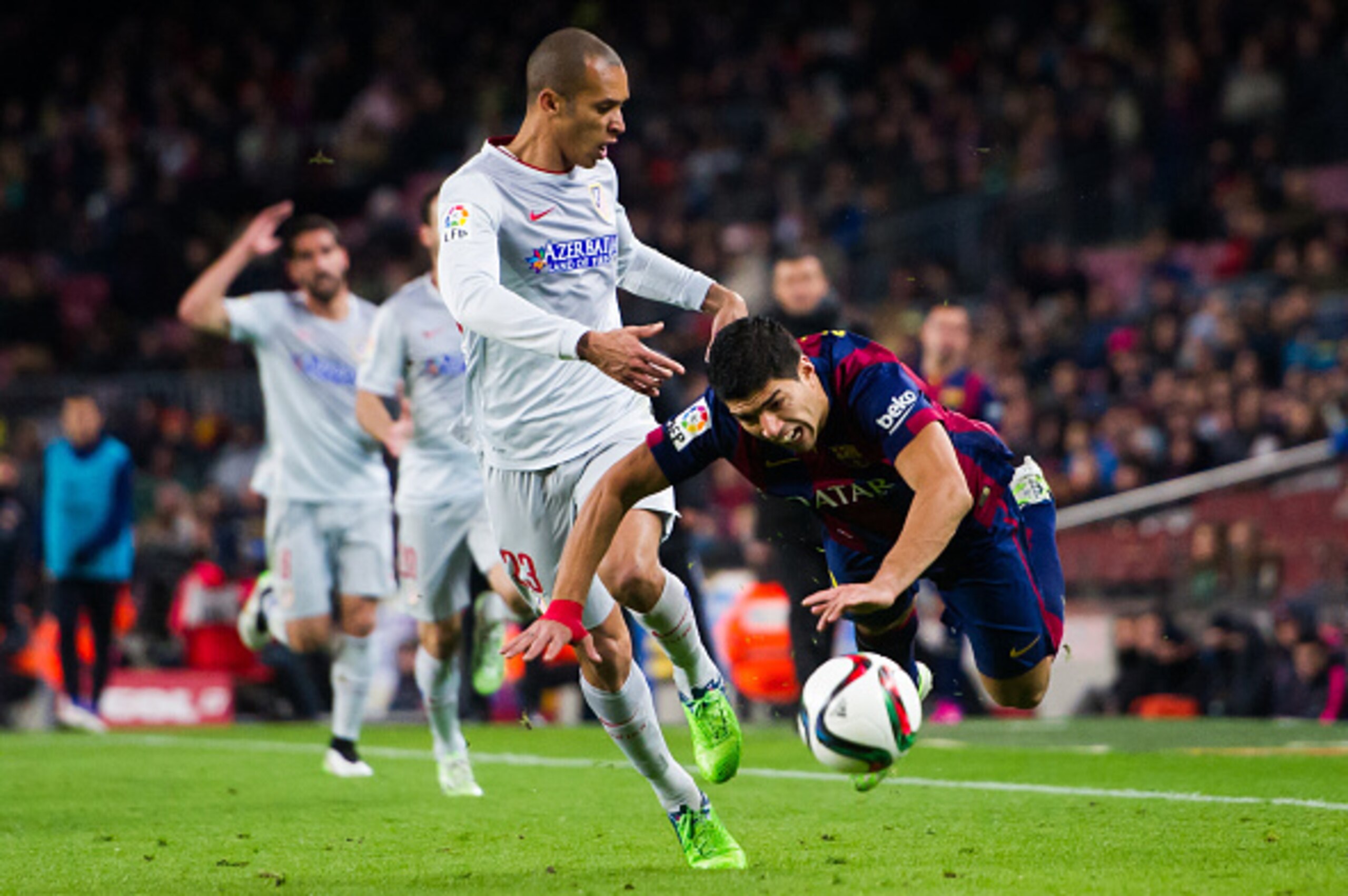 BARCELONA, SPAIN - JANUARY 21:  Luis Suarez of FC Barcelona is brought down by Joao Miranda of Club Atletico de Madrid during the Copa del Rey Quarter-Final First Leg match between FC Barcelona and Club Atletico de Madrid at Camp Nou on January 21, 2015 i
