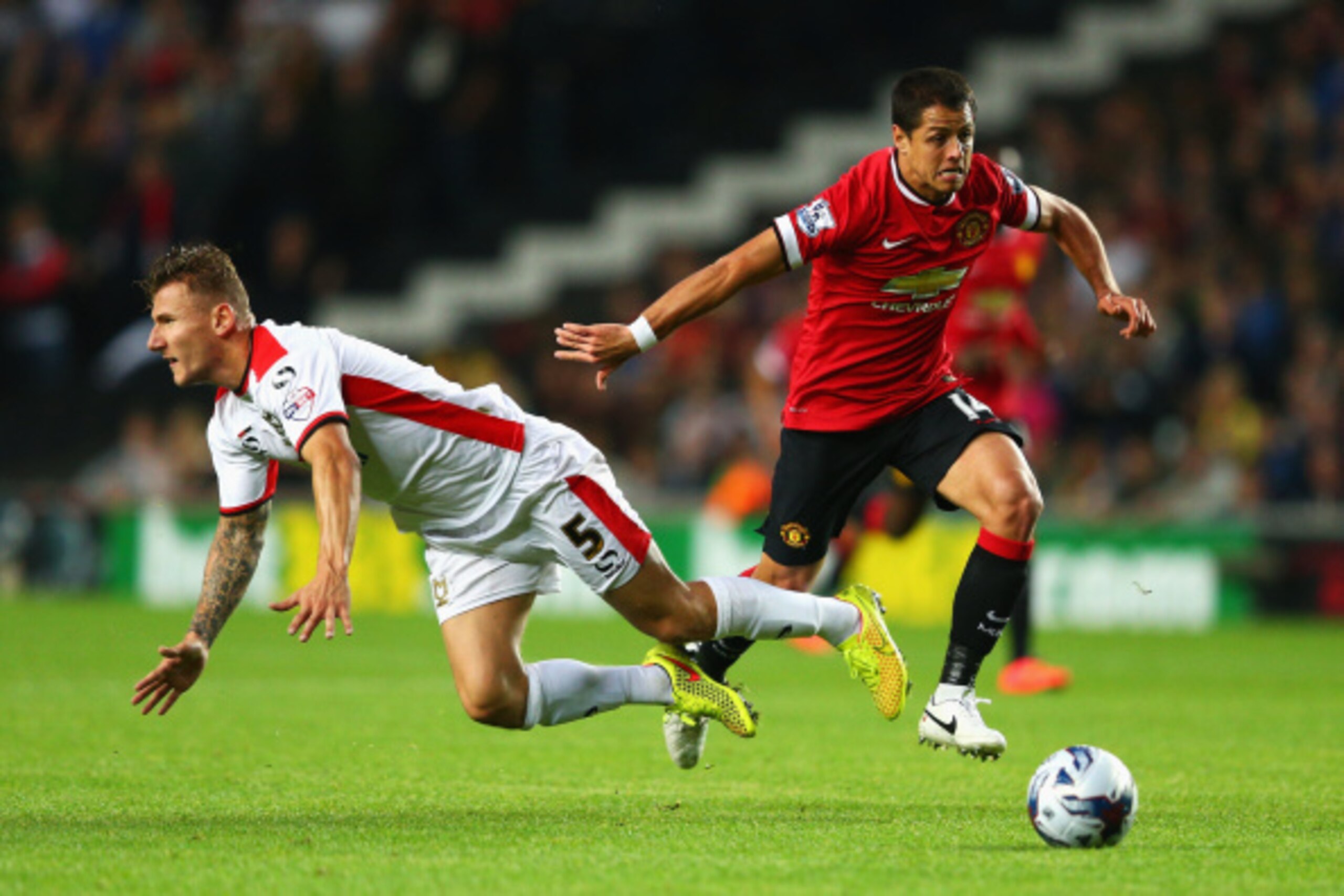 MILTON KEYNES, ENGLAND - AUGUST 26: Javier Hernandez of Manchester United goes past Kyle McFadzean of Milton Keynes Dons during the Capital One Cup Second Round match between MK Dons and Manchester United at Stadium mk on August 26, 2014 in Milton Keynes, MILTON KEYNES, ENGLAND - AUGUST 26: Javier Hernandez of Manchester United goes past Kyle McFadzean of Milton Keynes Dons during the Capital One Cup Second Round match between MK Dons and Manchester United at Stadium mk on August 26, 2014 in Milton Keynes,