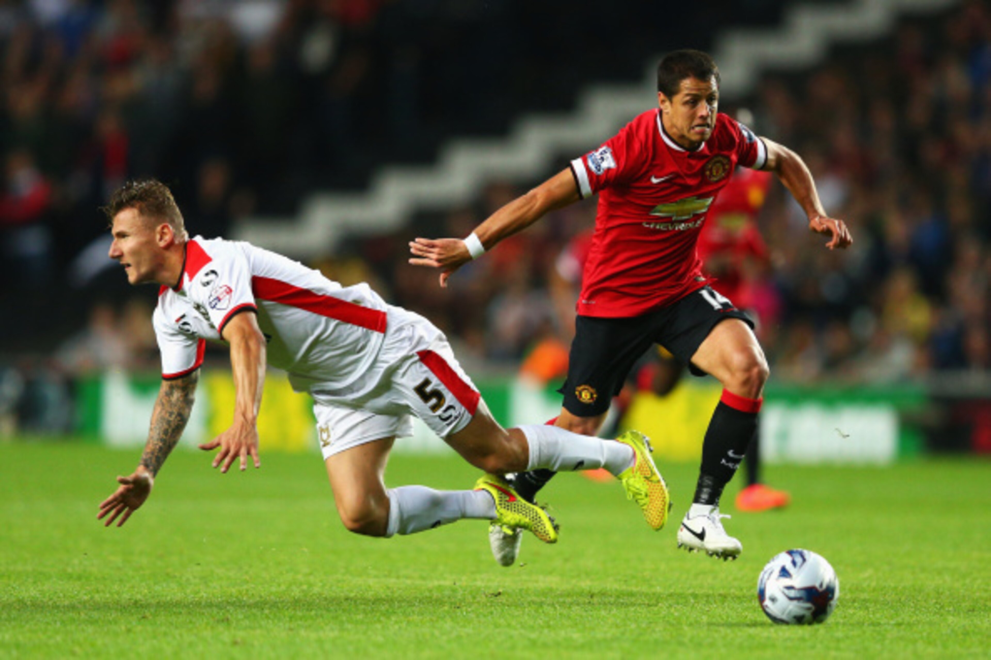 MILTON KEYNES, ENGLAND - AUGUST 26: Javier Hernandez of Manchester United goes past Kyle McFadzean of Milton Keynes Dons during the Capital One Cup Second Round match between MK Dons and Manchester United at Stadium mk on August 26, 2014 in Milton Keynes,