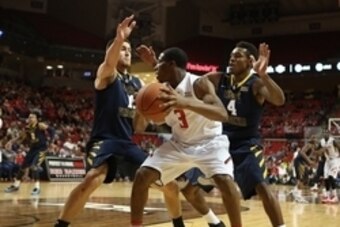Jan 5, 2015; Lubbock, TX, USA; Texas Tech Red Raiders guard Randy Onwuasor (3) works against the defensive press by West Virginia Mountaineers guard Daxter Miles (4) and forward Nathan Adrian (11) in the second half at United Supermarkets Arena. West Virg