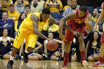 MORGANTOWN, WV - JANUARY 10:  Daxter Miles Jr. #4 of the West Virginia Mountaineers handles the ball against Bryce Dejean-Jones #13 of the Iowa State Cyclones at the WVU Coliseum on January 10, 2015 in Morgantown, West Virginia.  (Photo by Justin K. Aller