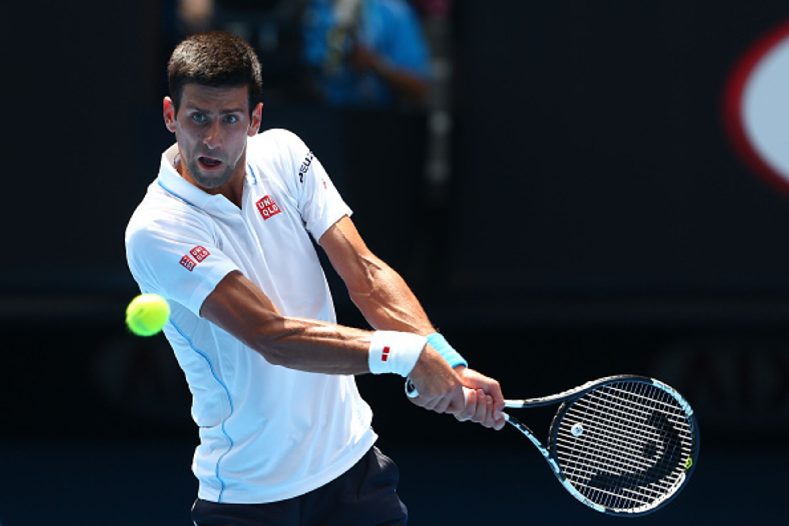 MELBOURNE, AUSTRALIA - JANUARY 22:  Novak Djokovic of Serbia plays a backhand in his second round match against Andrey Kuznetsov of Russia during day four of the 2015 Australian Open at Melbourne Park on January 22, 2015 in Melbourne, Australia.  (Photo b