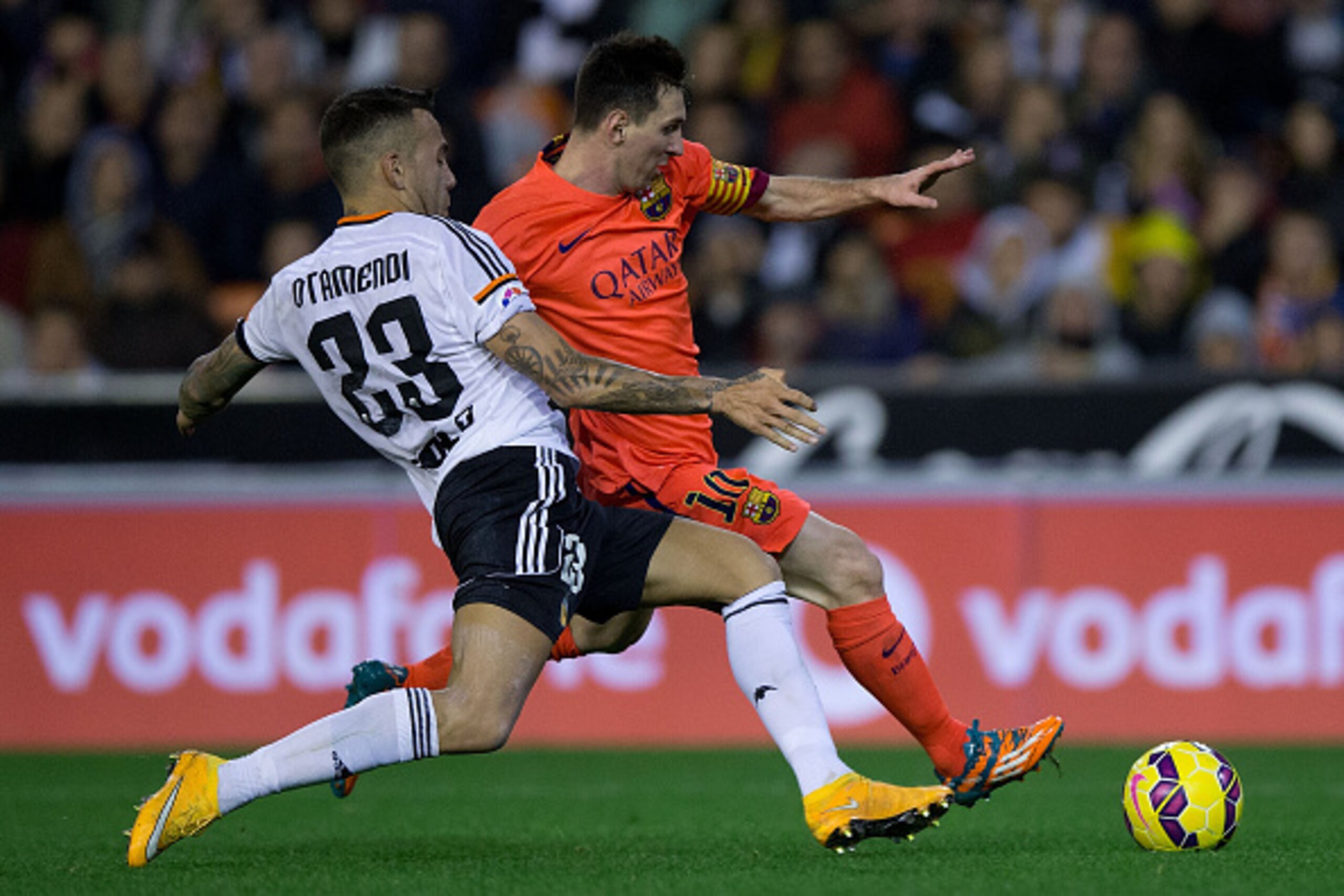 VALENCIA, SPAIN - NOVEMBER 30: Lionel Messi (R) of FC Barcelona competes for the ball with Nicolas Otamendi (L) of Valencia CF during the La Liga match between Valencia CF and FC Barcelona at Estadi de Mestalla on November 30, 2014 in Valencia, Spain.  (P