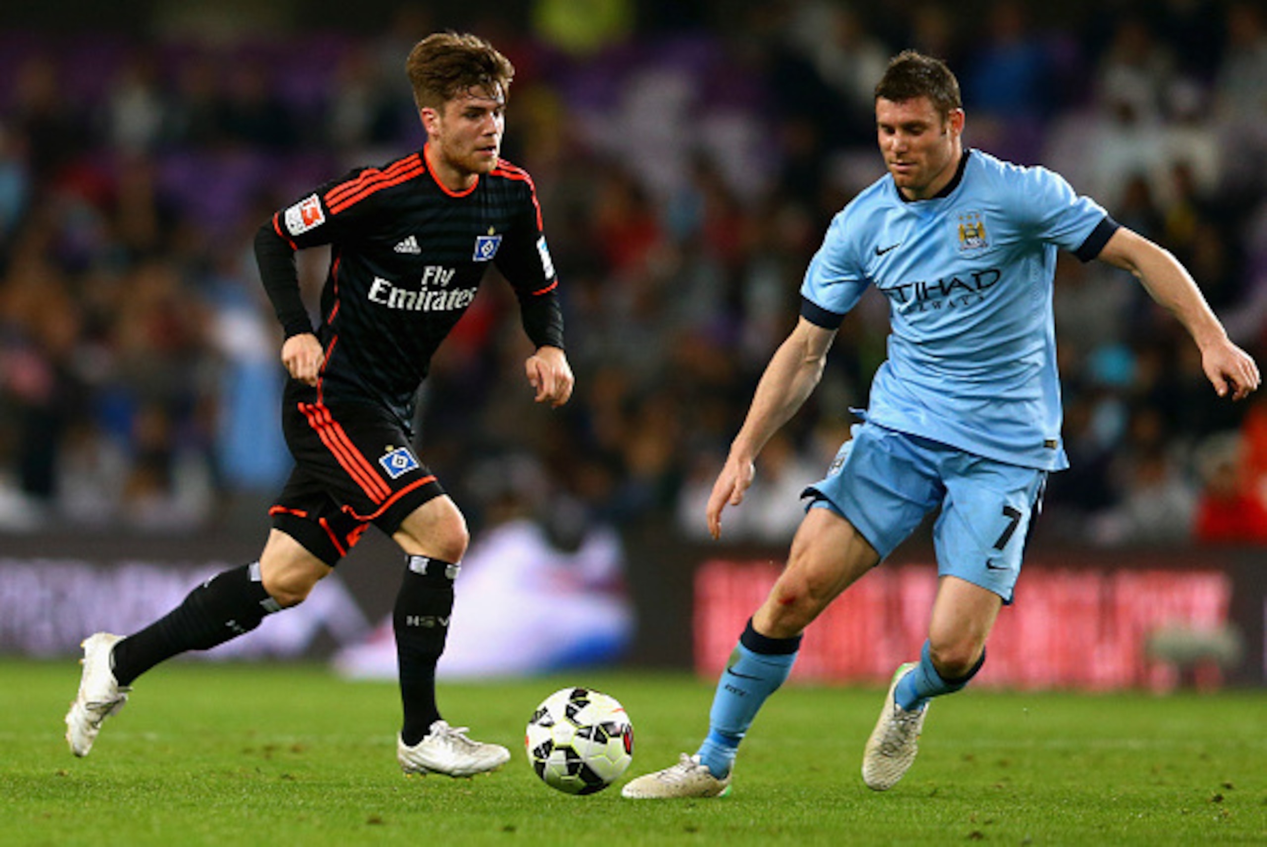 AL AIN, UNITED ARAB EMIRATES - JANUARY 21: Phillip Muller of Hamburg controls the ball against James Milner of Manchester City during the friendly match between Hamburg SV and Manchester City at Hazza bin Zayed Stadium on January 21, 2015 in Al Ain, Unite