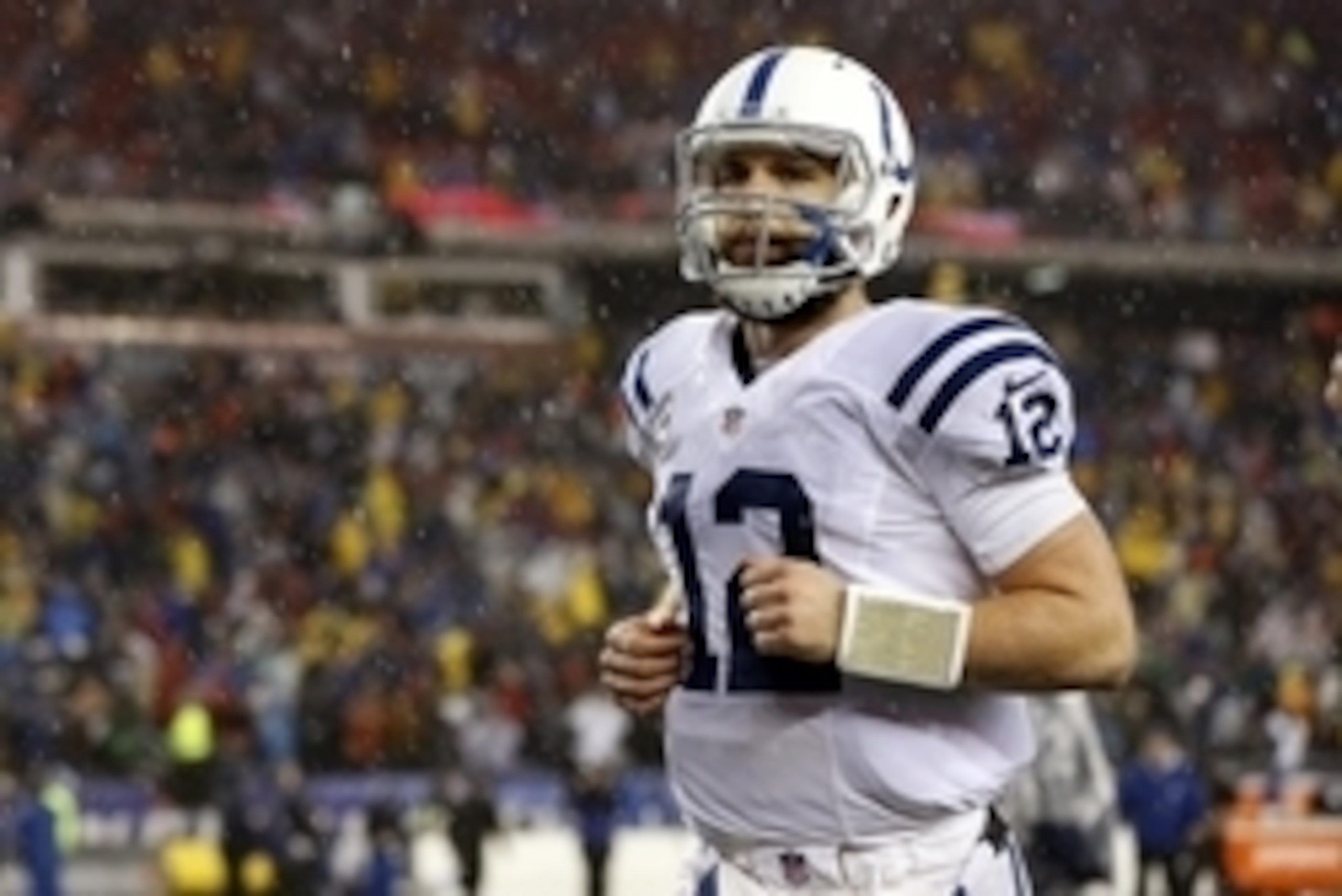 Jan 18, 2015; Foxborough, MA, USA; Indianapolis Colts quarterback Andrew Luck (12) runs off the field after losing to the New England Patriots in the AFC Championship Game at Gillette Stadium. Mandatory Credit: Greg M. Cooper-USA TODAY Sports