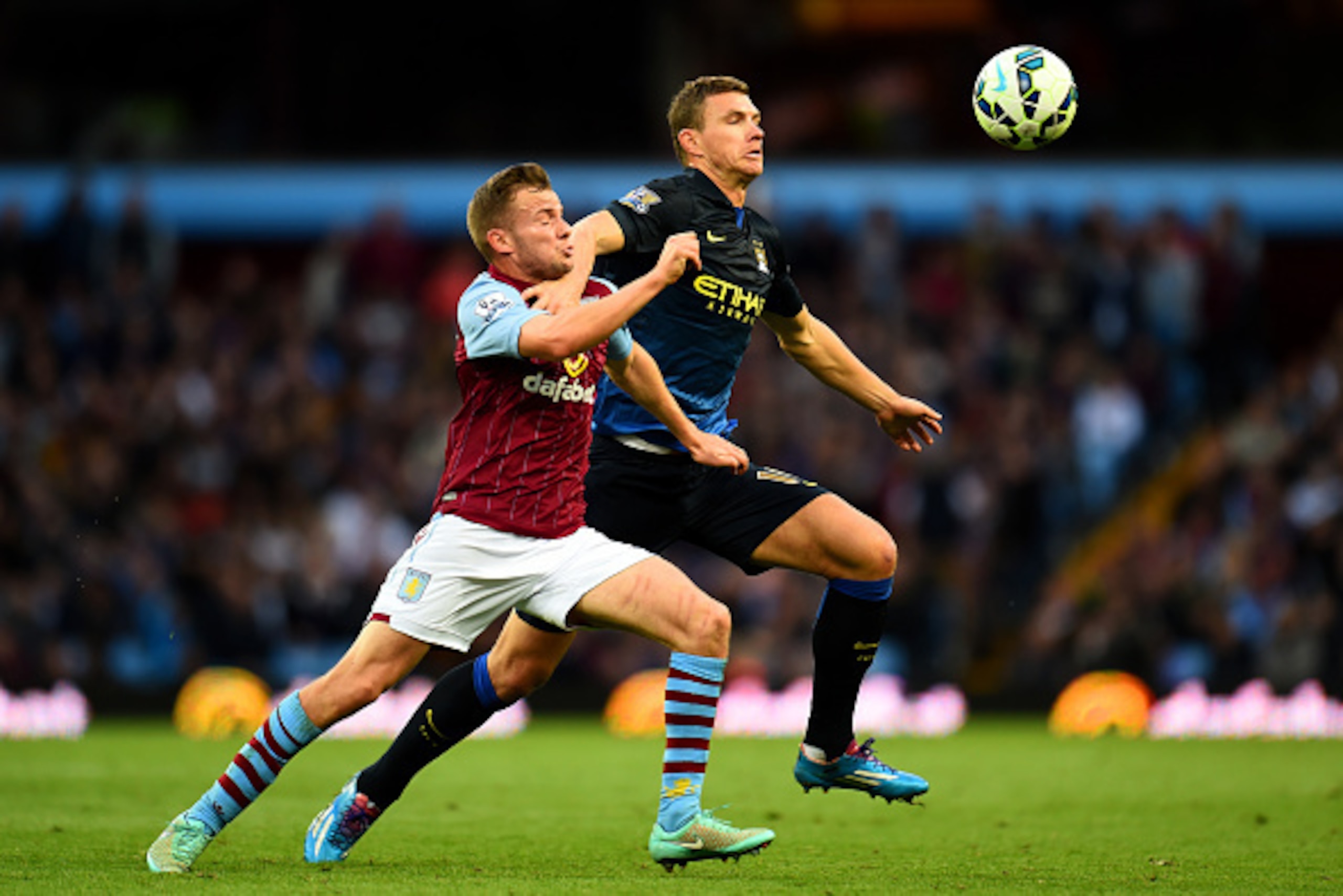 BIRMINGHAM, ENGLAND - OCTOBER 04:  Tom Cleverley of Aston Villa battles for the ball with Edin Dzeko of Manchester City during the Barclays Premier League match between Aston Villa and Manchester City at Villa Park on October 4, 2014 in Birmingham, Englan