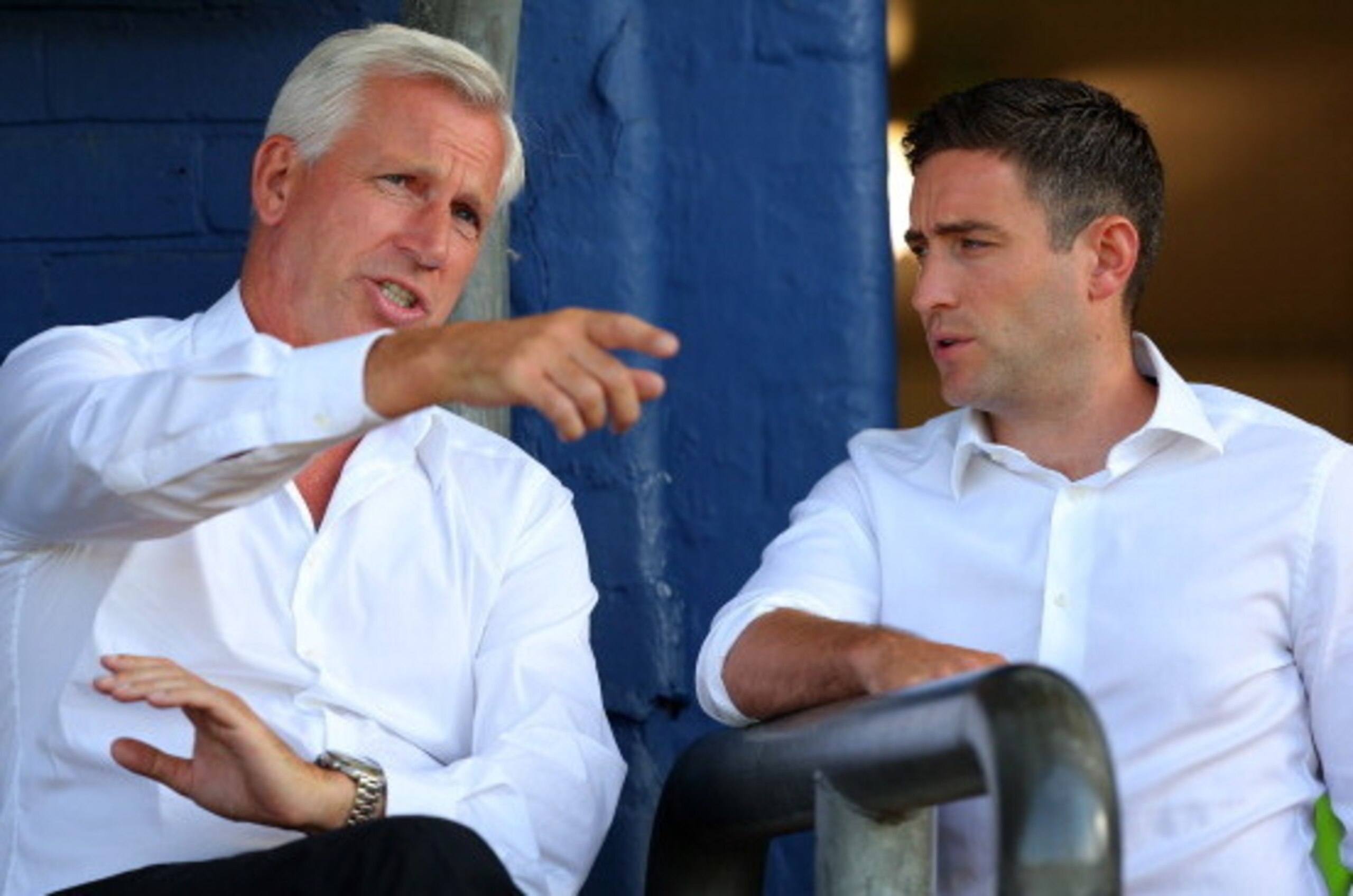 OLDHAM, ENGLAND - JULY 15: Alan Pardew, manager of Newcastle United, talks to Oldham Athletic manager Lee Johnson (R) during the pre season friendly at SportsDirect.com Park on July 15, 2014 in Oldham, England.  (Photo by Dave Thompson/Getty Images)