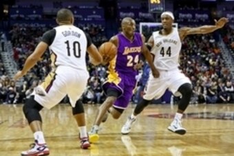 Jan 21, 2015; New Orleans, LA, USA; Los Angeles Lakers guard Kobe Bryant (24) drives past New Orleans Pelicans forward Dante Cunningham (44) and guard Eric Gordon (10) during the second quarter of a game at the Smoothie King Center. Mandatory Credit: Deri
