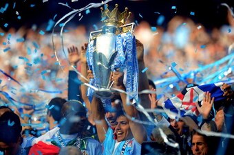 MANCHESTER, ENGLAND - MAY 13:  Scorer of the matchwinning goal Sergio Aguero of Manchester City celebrates with the trophy during the Barclays Premier League match between Manchester City and Queens Park Rangers at the Etihad Stadium on May 13, 2012 in Ma