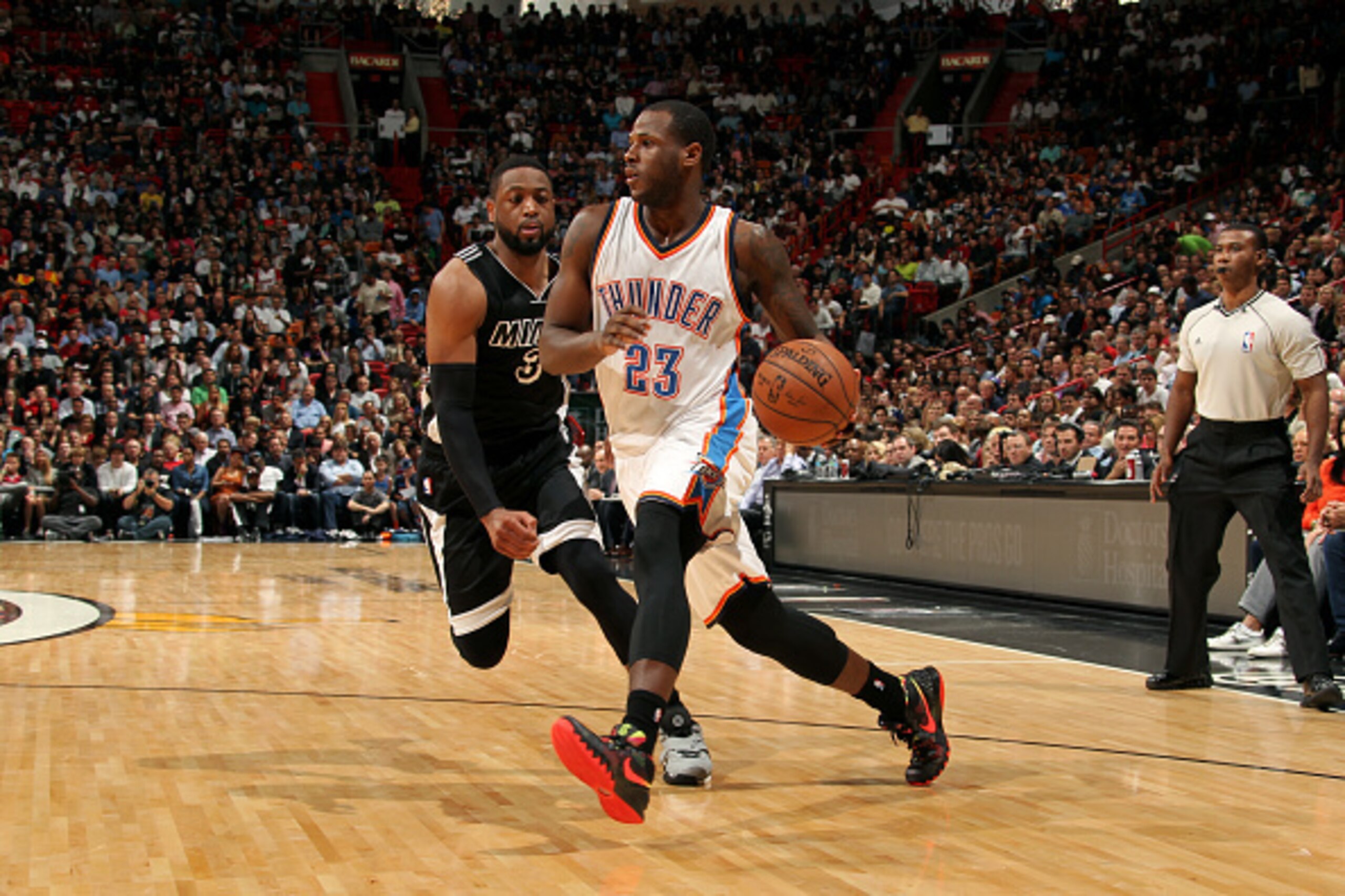 MIAMI, FL - JANUARY 20: Dion Waiters #23 of the Oklahoma City Thunder drives against Dwyane Wade #3 of the Miami Heat on January 20, 2015 at American Airlines Arena in Miami, Florida. NOTE TO USER: User expressly acknowledges and agrees that, by downloadi