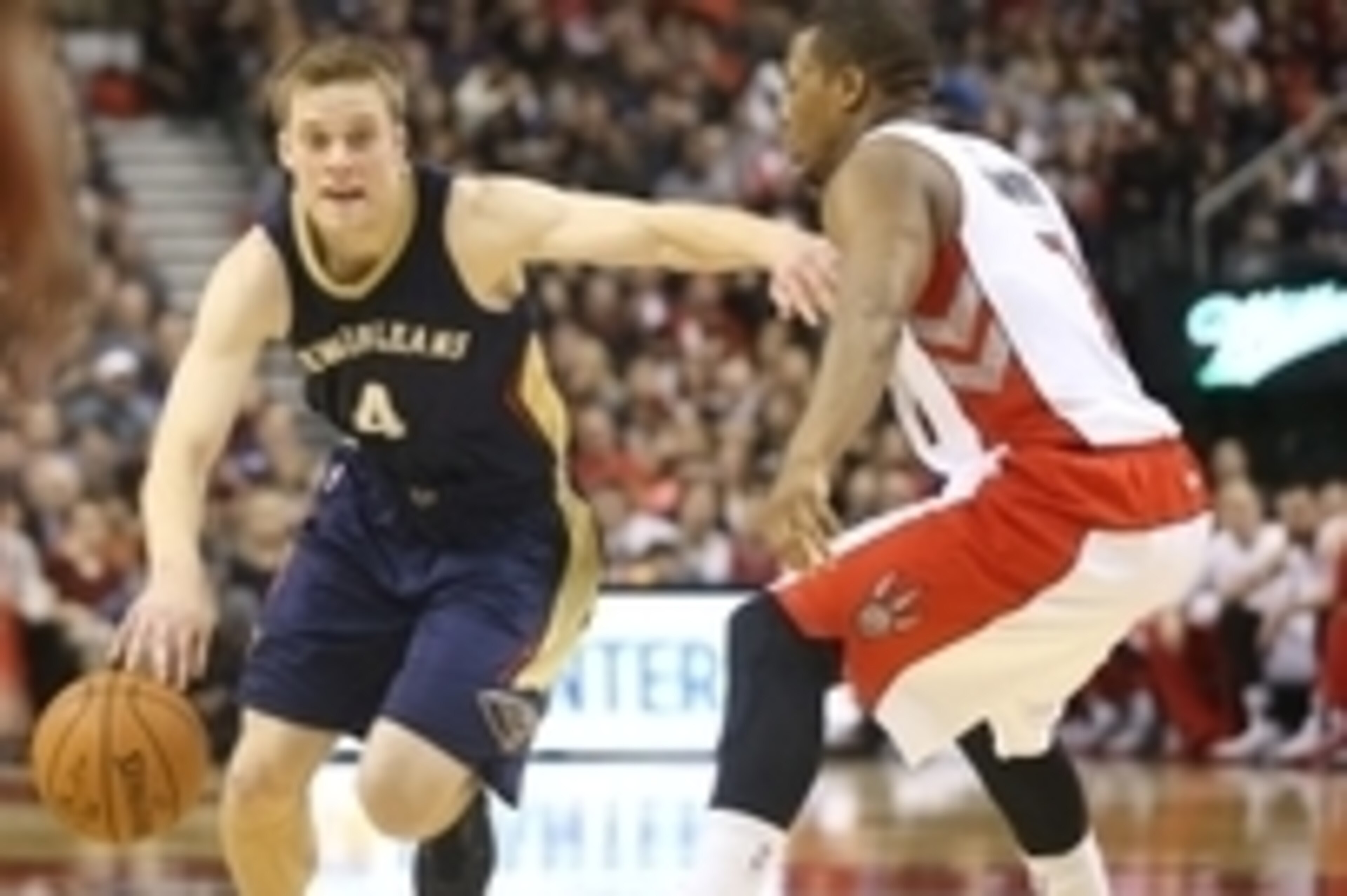 Jan 18, 2015; Toronto, Ontario, CAN; New Orleans Pelicans guard Nate Wolters (4) goes to the basket against Toronto Raptors point guard Kyle Lowry (7) at Air Canada Centre. The Pelicans beat the Raptors 95-93. Mandatory Credit: Tom Szczerbowski-USA TODAY 