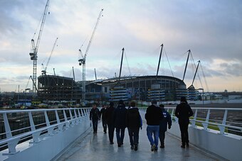 MANCHESTER, ENGLAND - JANUARY 18:  Fans walk to the stadium prior to the Barclays Premier League match between Manchester City and Arsenal at Etihad Stadium on January 18, 2015 in Manchester, England.  (Photo by Michael Steele/Getty Images)