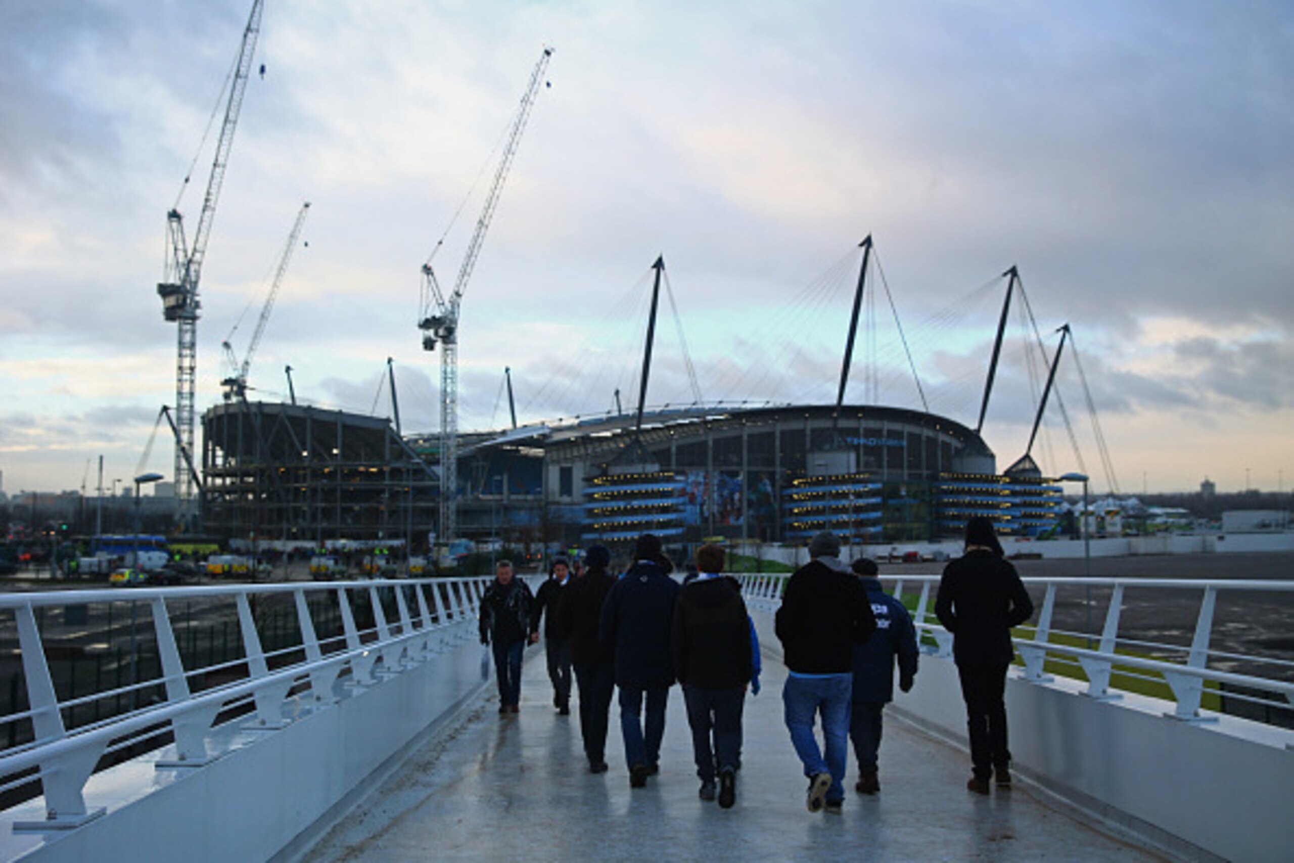 MANCHESTER, ENGLAND - JANUARY 18:  Fans walk to the stadium prior to the Barclays Premier League match between Manchester City and Arsenal at Etihad Stadium on January 18, 2015 in Manchester, England.  (Photo by Michael Steele/Getty Images)