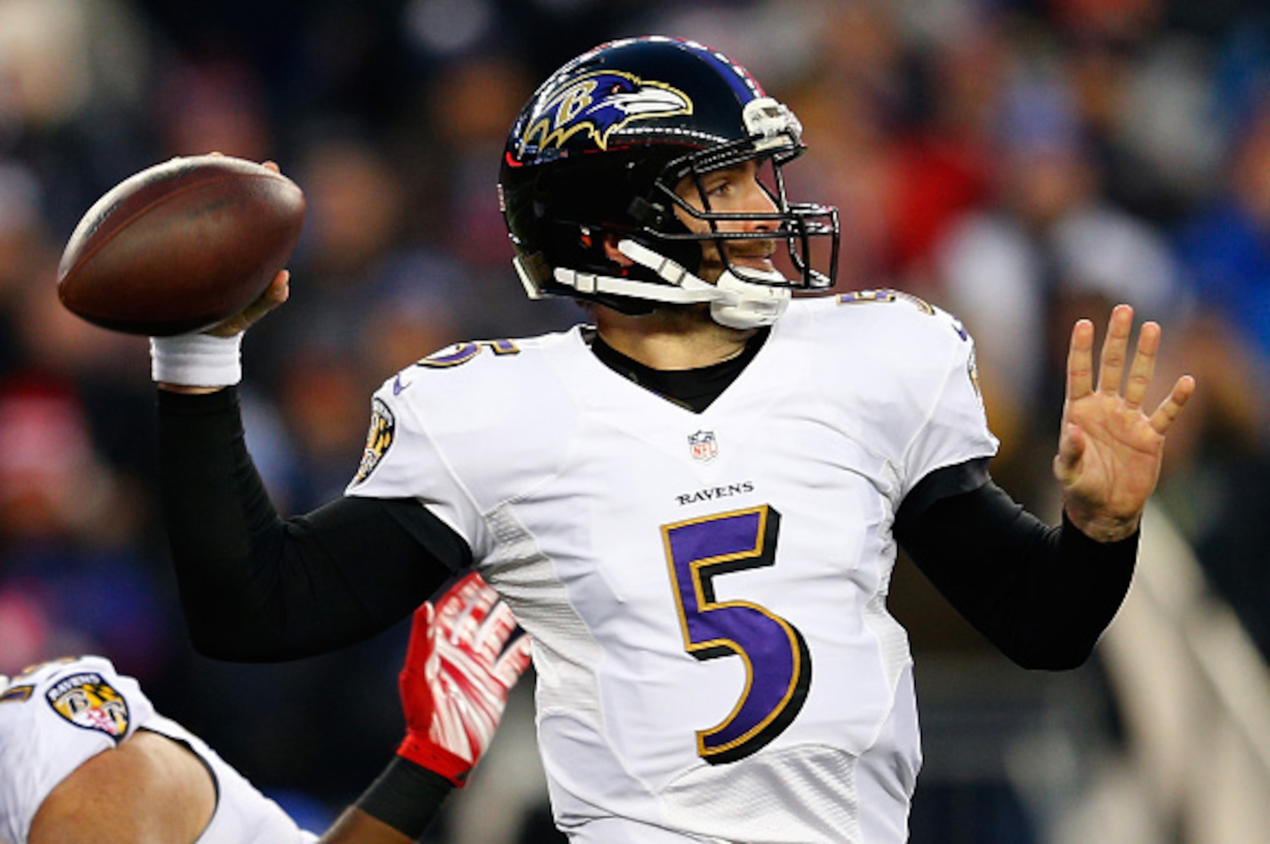 FOXBORO, MA - JANUARY 10:  Joe Flacco #5 of the Baltimore Ravens looks to pass in the first quarter against the New England Patriots during the 2014 AFC Divisional Playoffs game at Gillette Stadium on January 10, 2015 in Foxboro, Massachusetts.  (Photo by