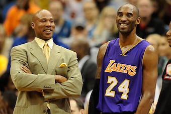 MINNEAPOLIS, MN - DECEMBER 14: Byron Scott of the Los Angeles Lakers speaks with Kobe Bryant #24 during a time out in the fourth quarter of the game against the Minnesota Timberwolves on December 14, 2014 at Target Center in Minneapolis, Minnesota. The La