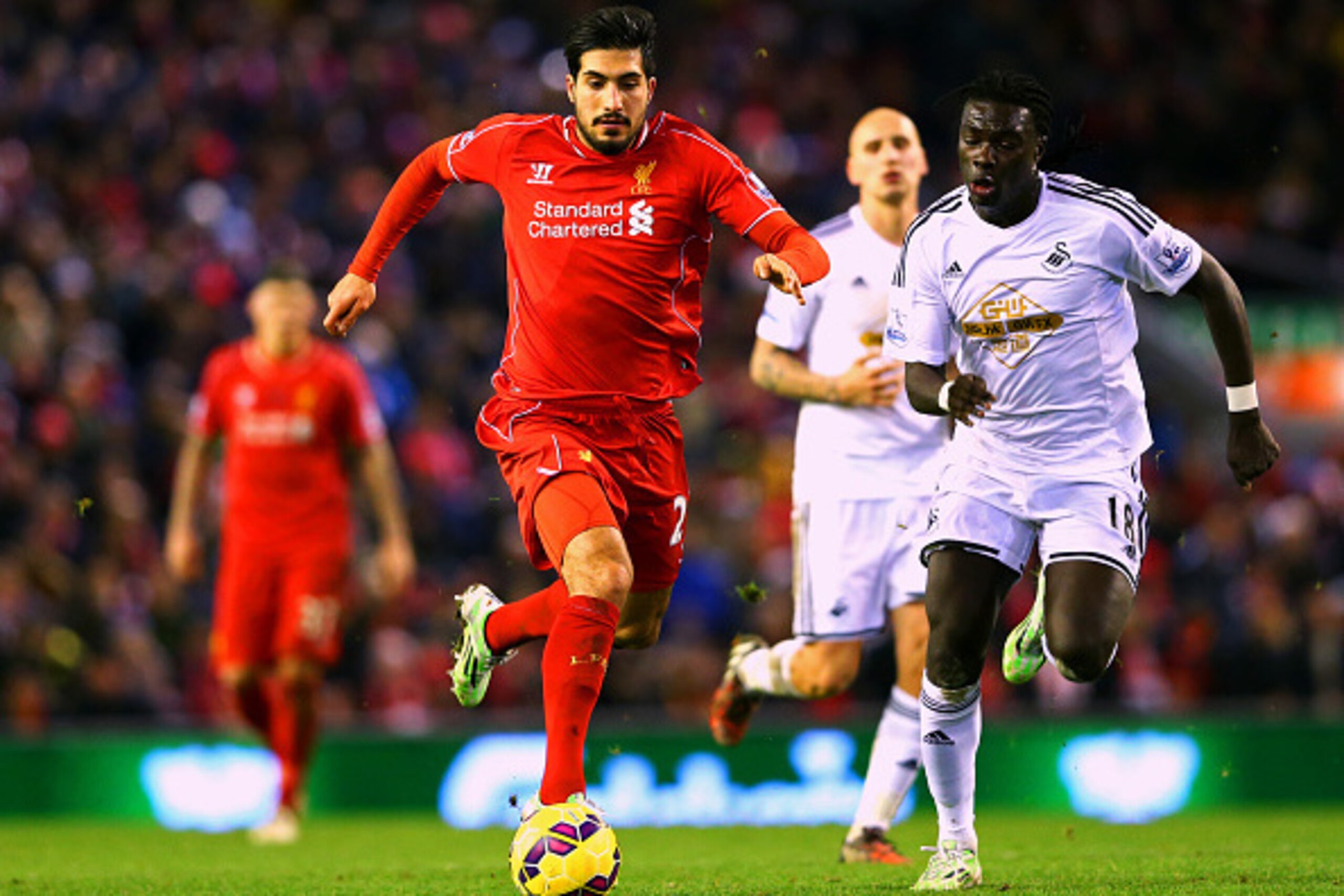 LIVERPOOL, ENGLAND - DECEMBER 29:  Emre Can of Liverpool battles for the ball with Bafetibis Gomis of Swansea City during the Barclays Premier League match between Liverpool and Swansea City at Anfield on December 29, 2014 in Liverpool, England.  (Photo b