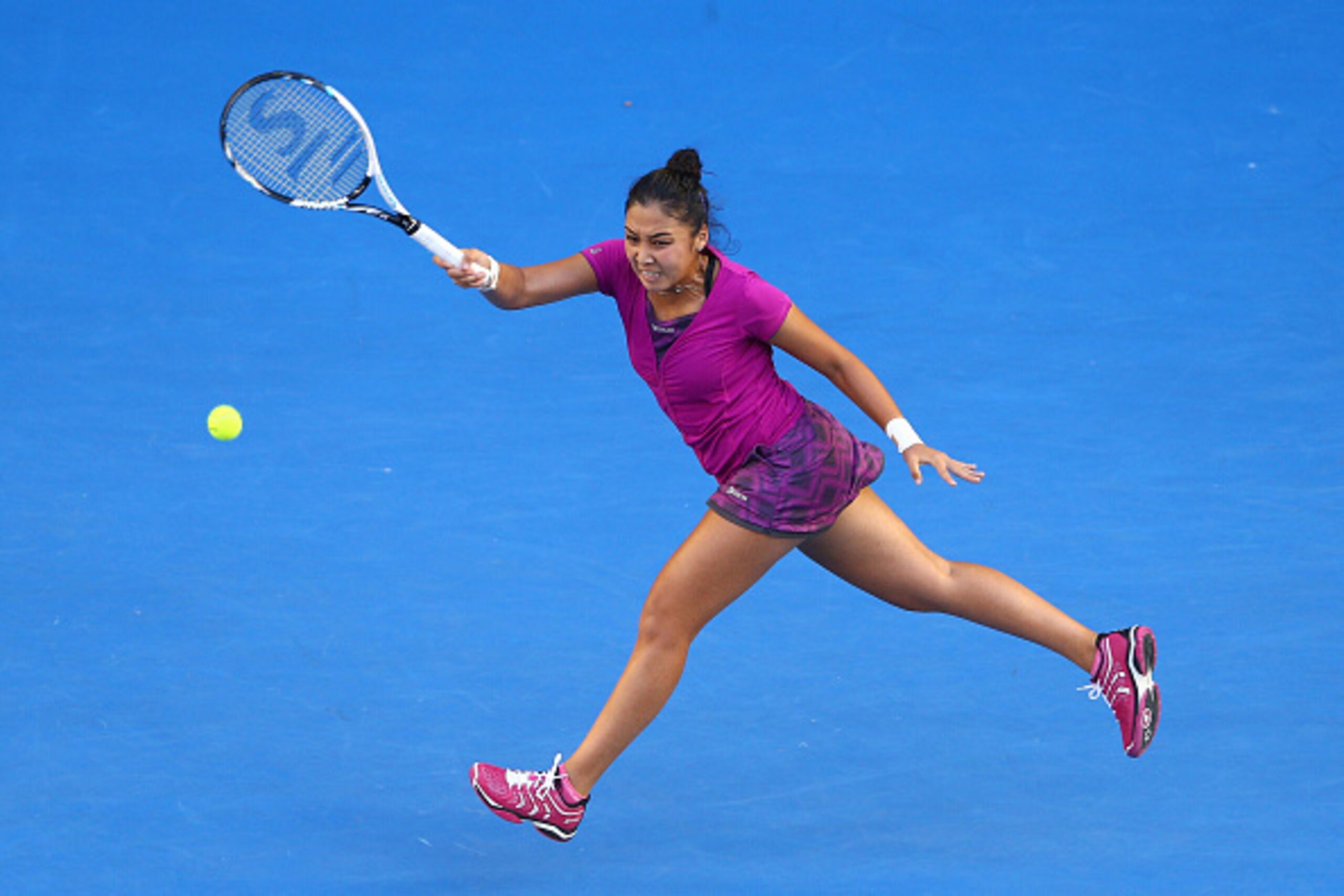 MELBOURNE, AUSTRALIA - JANUARY 23:  Zarina Diyas of Kazakhstan plays a forehand in her third round match against Maria Sharapova of Russia during day five of the 2015 Australian Open at Melbourne Park on January 23, 2015 in Melbourne, Australia.  (Photo b