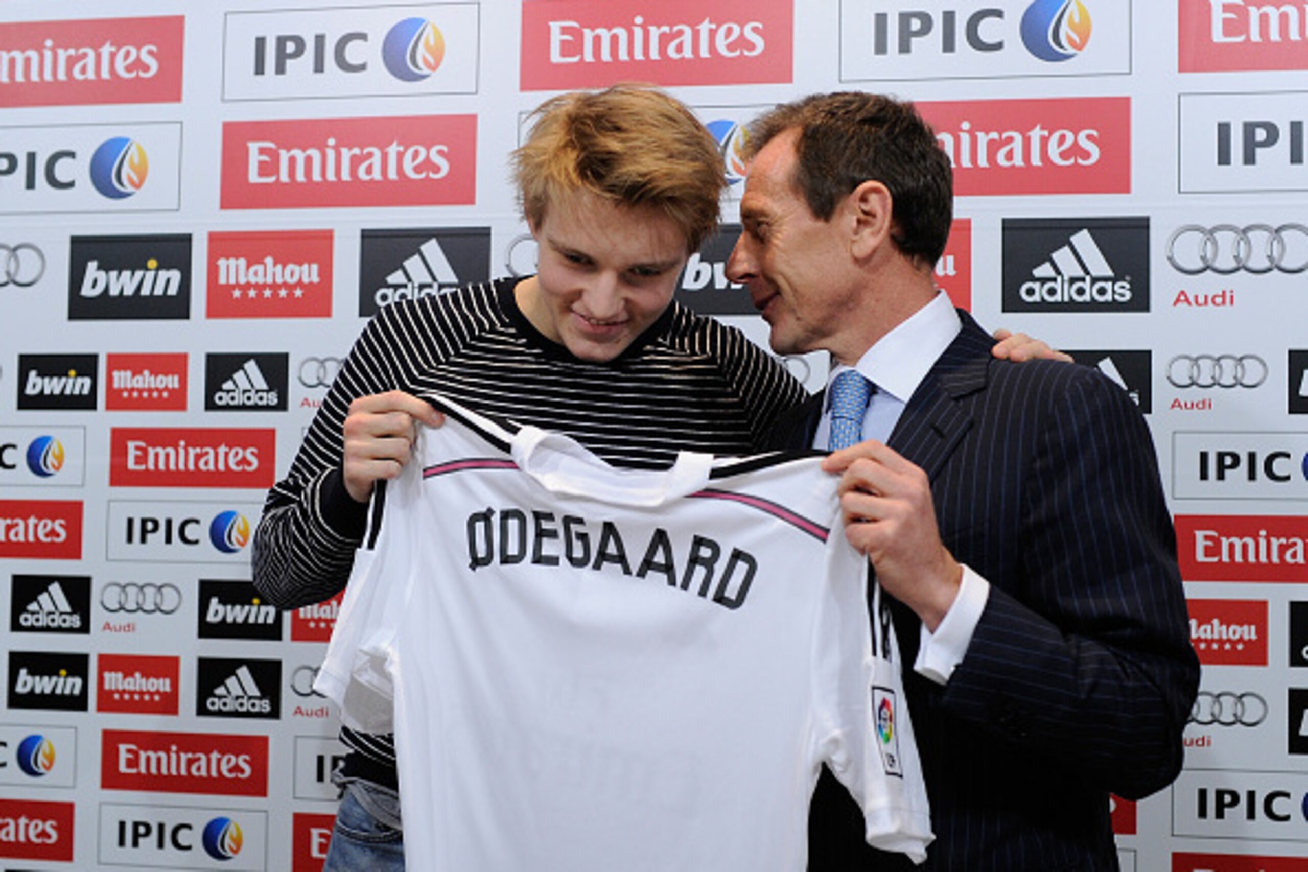 MADRID, SPAIN - JANUARY 22:  Martin Odegaard from Norway holds his new Real Madrid shirt with former Real player Emilio Butragueno during a press conference at Real Madrid's Valdebebas training grounds after he signed with Real on January 22, 2015 in Madr