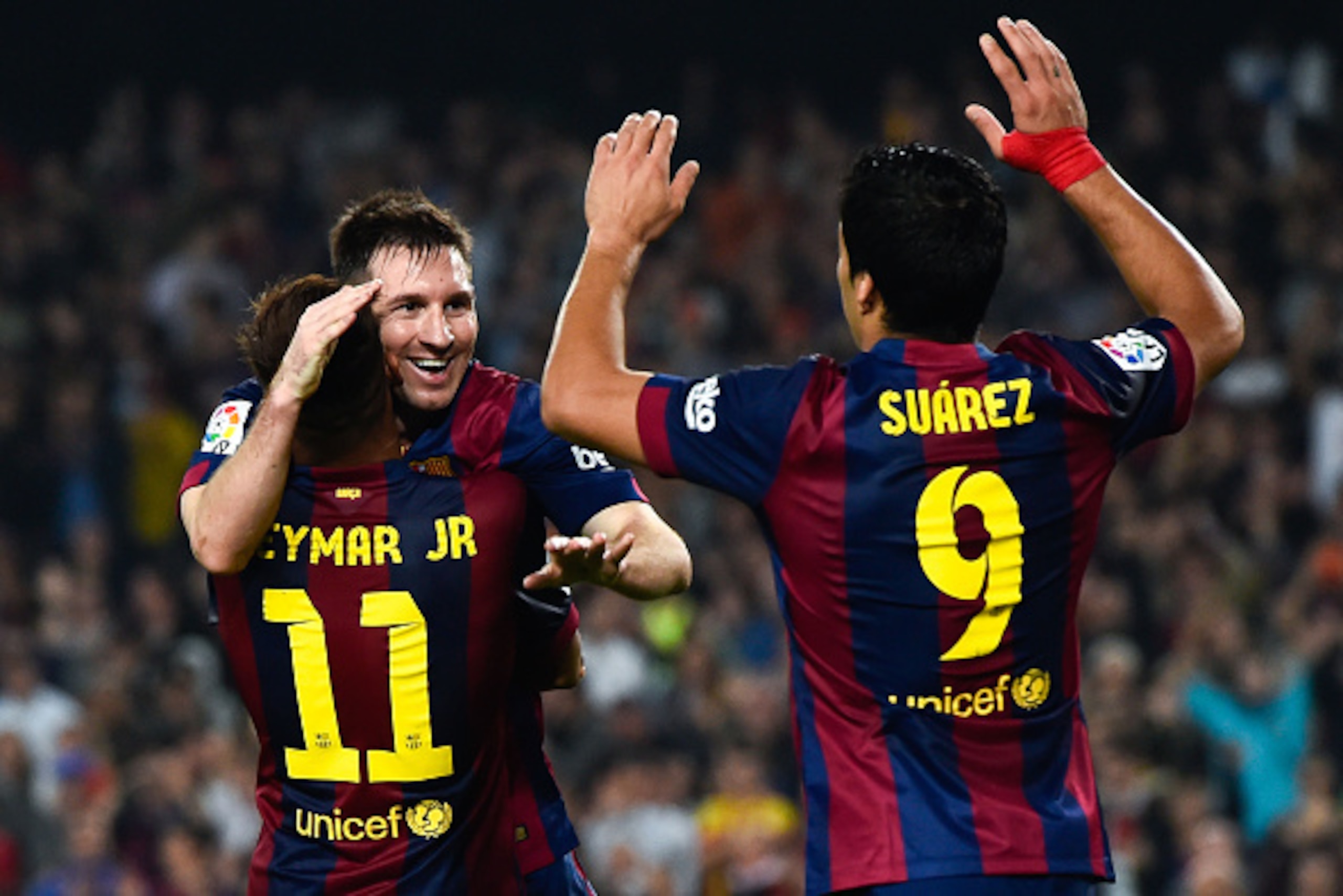 BARCELONA, SPAIN - NOVEMBER 22:  Lionel Messi of FC Barcelona celebrates with his teammates Neymar (L) and Luis Suarez of FC Barcelona after scoring his team's fourth goal during the La Liga match between FC Barcelona and Sevilla FC at Camp Nou on Novembe