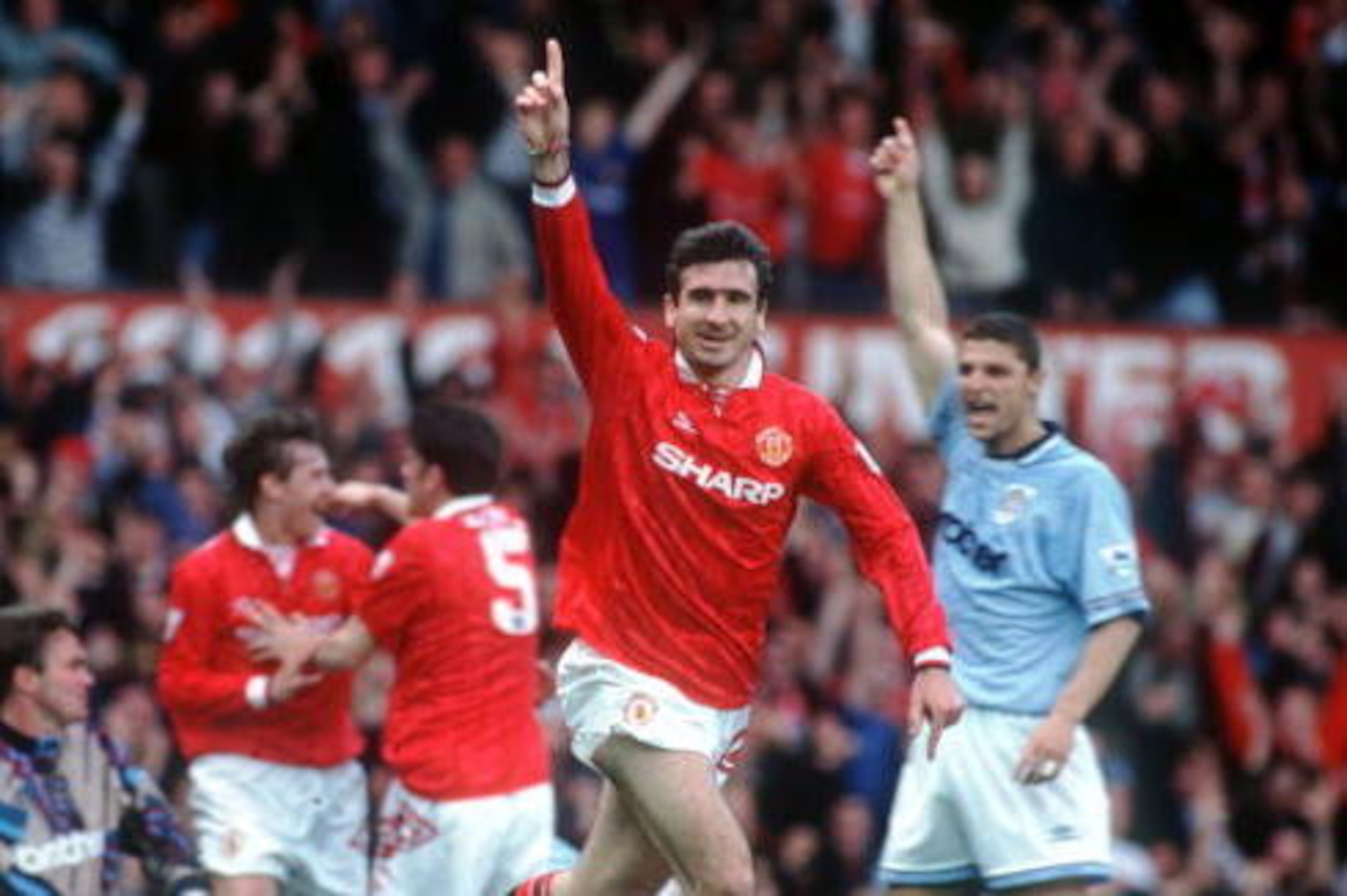 23 APR 1994:  A PICTURE SHOWING ERIC CANTONA OF MANCHESTER UNITED FOOTBALL CLUB AS HE RUNS OFF WITH HIS ARM RAISED IN CELEBRATION AFTER SCORING THE FIRST GOAL IN HIS FIRST GAME AFTER HIS SUSPENSION AGAINST MANCESTER CITY IN THEIR PREMIER LEAGUE MATCH Mand