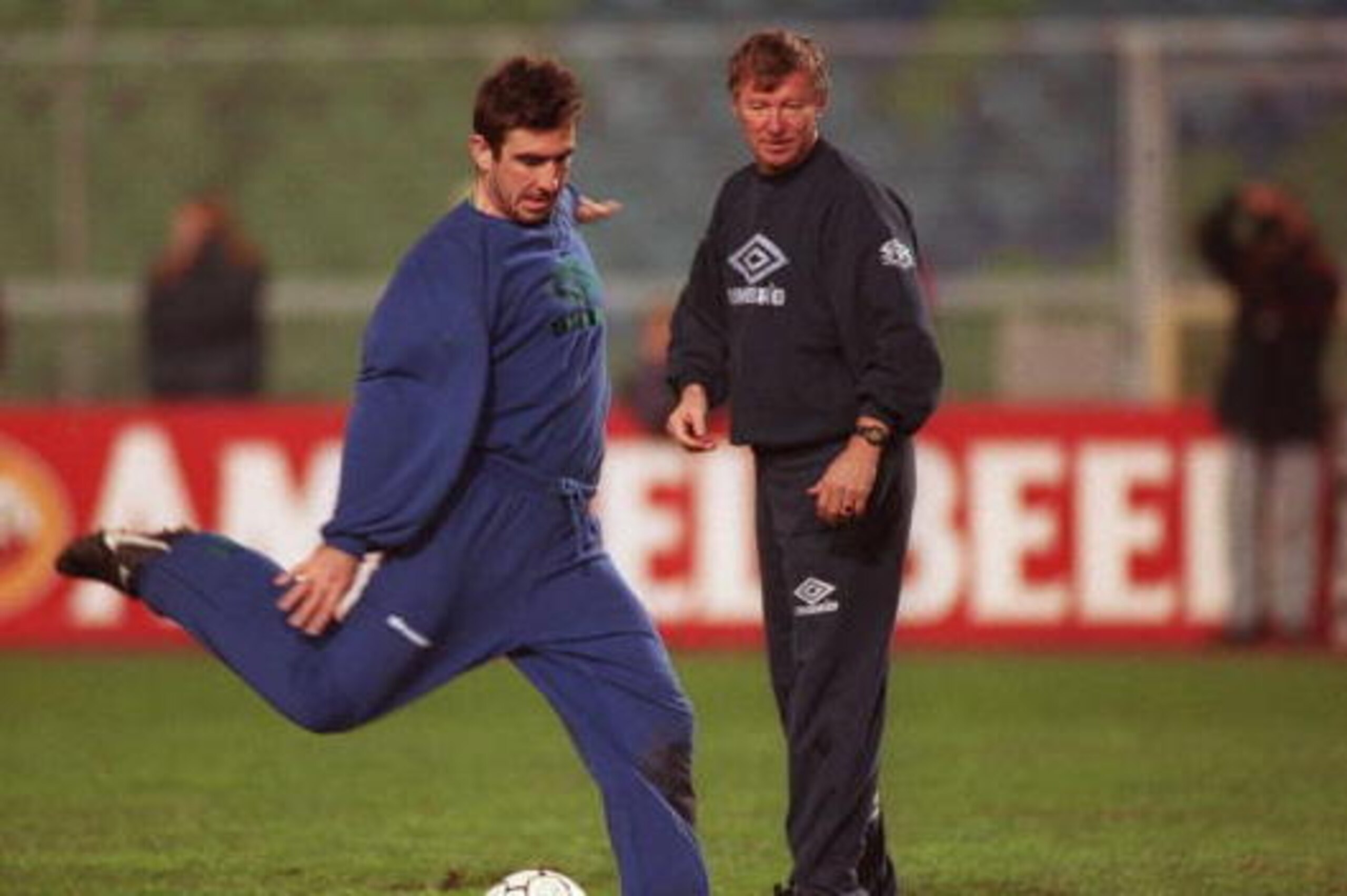 22 NOV 1994:  ERIC CANTONA OF MANCHESTER UNITED FIRES A SHOT AT GOAL DURING TRAINING TODAY AS CLUB MANAGER ALEX FERGUSON WATCHES IN THE BACKGROUND. CANTONA RETURNS TO THE SQUAD FOR THE EUROOEAN CHAMPIONS LEAGUE MATCH AGAINST GOTHENBURG TOMORROW AFTER A LO