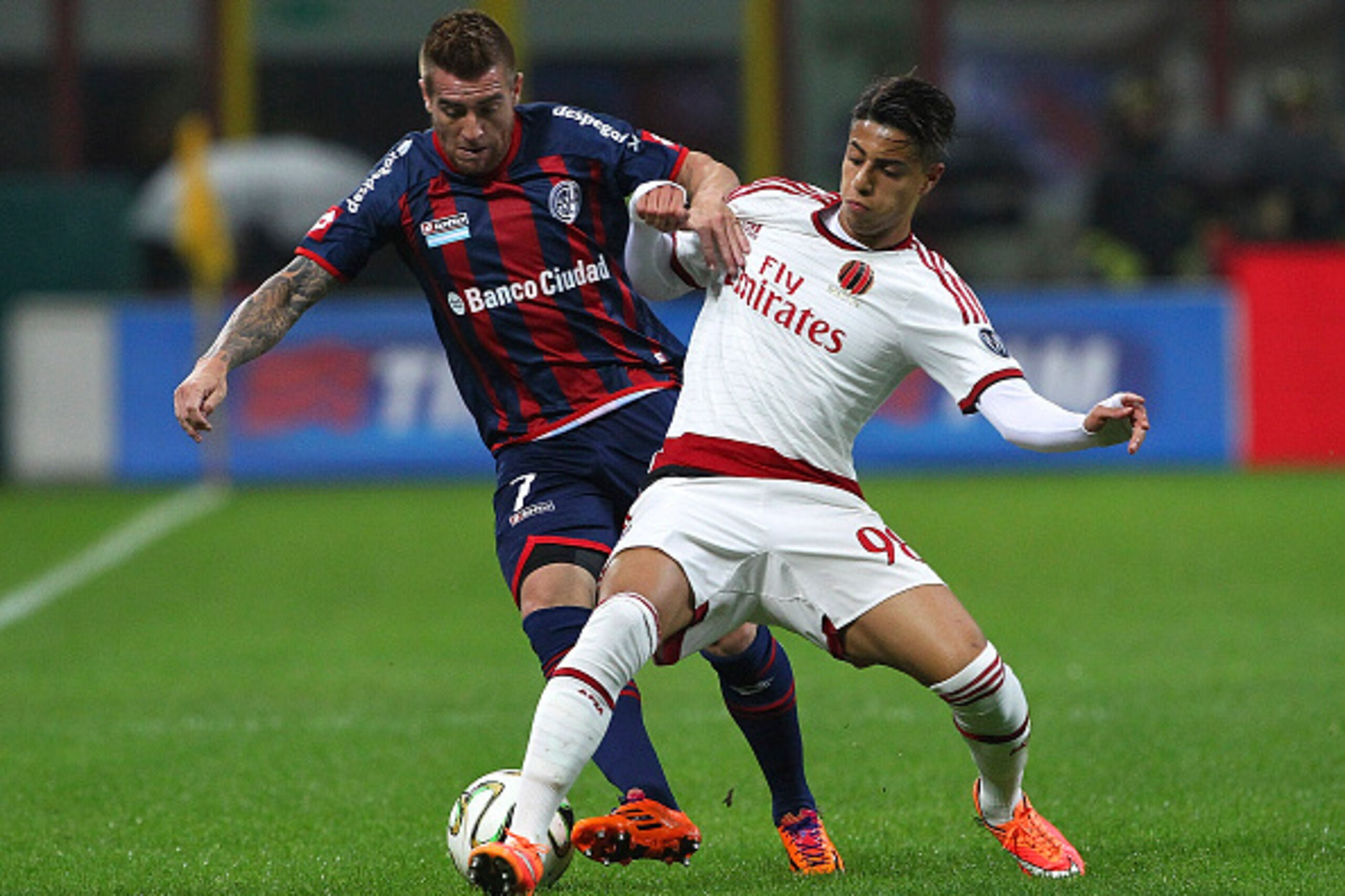 MILAN, ITALY - NOVEMBER 05:  Julio Alberto Buffarini of San Lorenzo competes for the ball with Hachim Mastour of AC Milan during Luigi Berlusconi Trophy at Stadio Giuseppe Meazza on November 5, 2014 in Milan, Italy.  (Photo by Marco Luzzani/Getty Images)