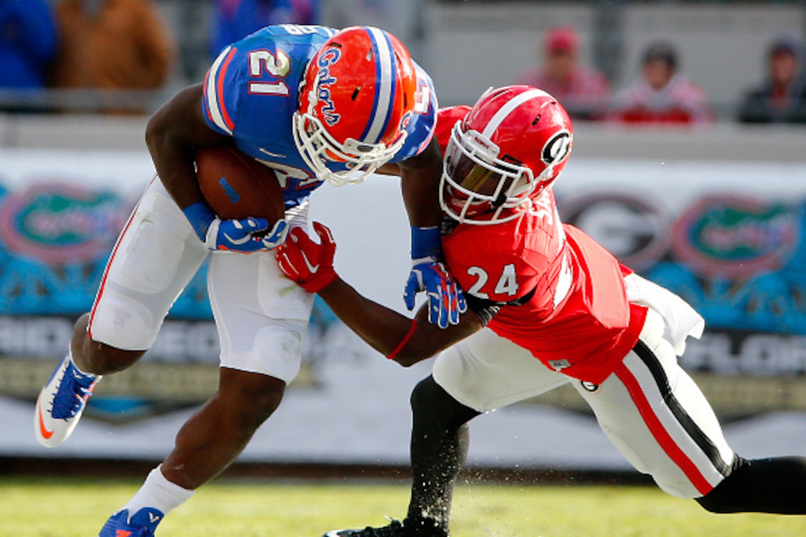 JACKSONVILLE, FL - NOVEMBER 01: Dominick Sanders #24 of the Georgia Bulldogs attempts to tackle Kelvin Taylor #21 of the Florida Gators during the game at EverBank Field on November 1, 2014 in Jacksonville, Florida.  (Photo by Sam Greenwood/Getty Images)