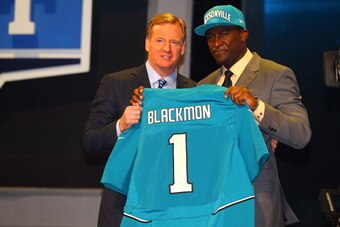 NEW YORK, NY - APRIL 26:  Justin Blackmon (R) from Oklahoma State holds up a jersey as he stands on stage with NFL Commissioner Roger Goodell after he was selected #5 overall by the Jacksonville Jaguars in the first round of the 2012 NFL Draft at Radio Ci