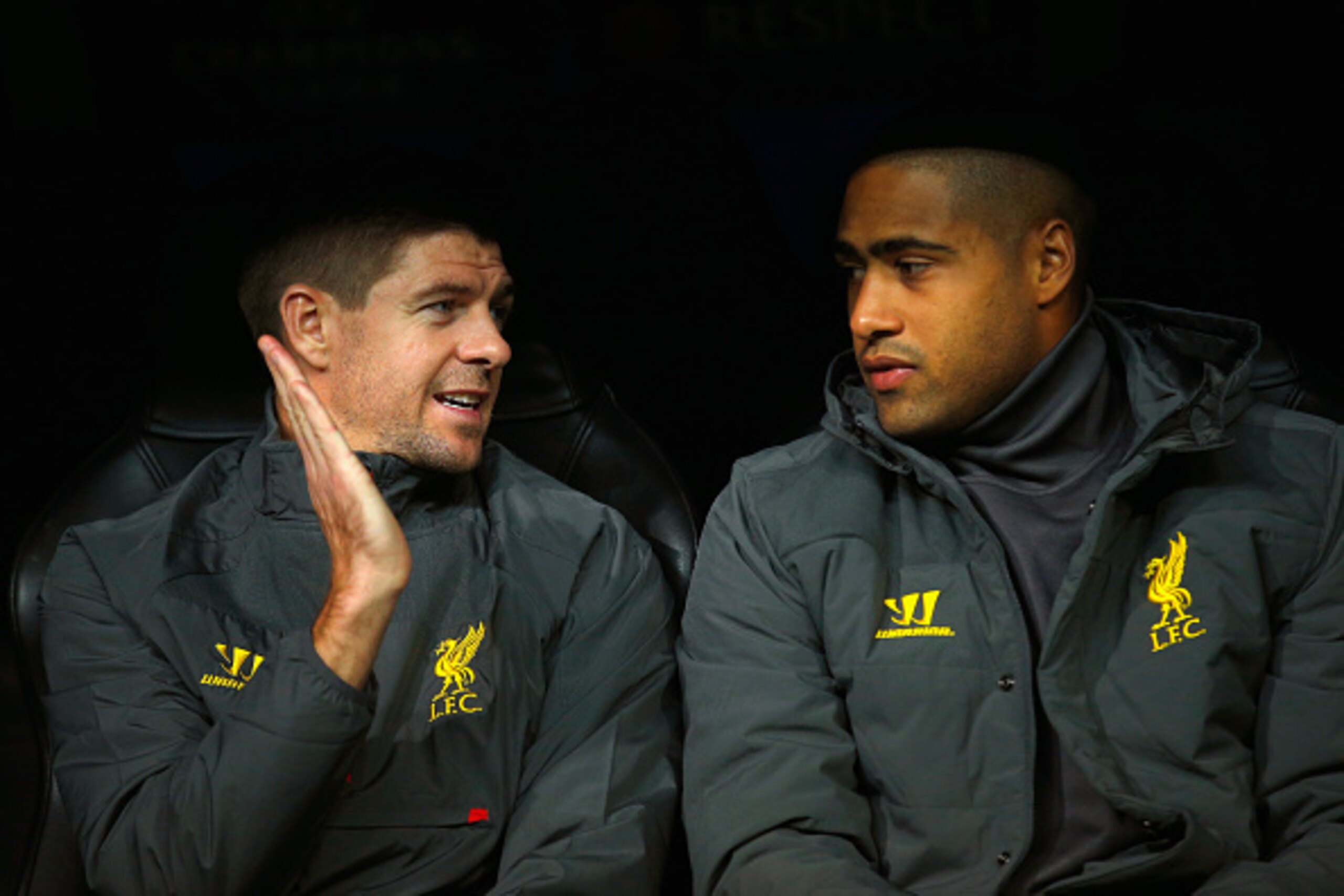 MADRID, SPAIN - NOVEMBER 04:  (L-R) Steven Gerrard. Glen Johnson of Liverpool talk as they sit on substitute the bench during the UEFA Champions League Group B match between Real Madrid CF and Liverpool FC at Estadio Santiago Bernabeu on November 4, 2014 