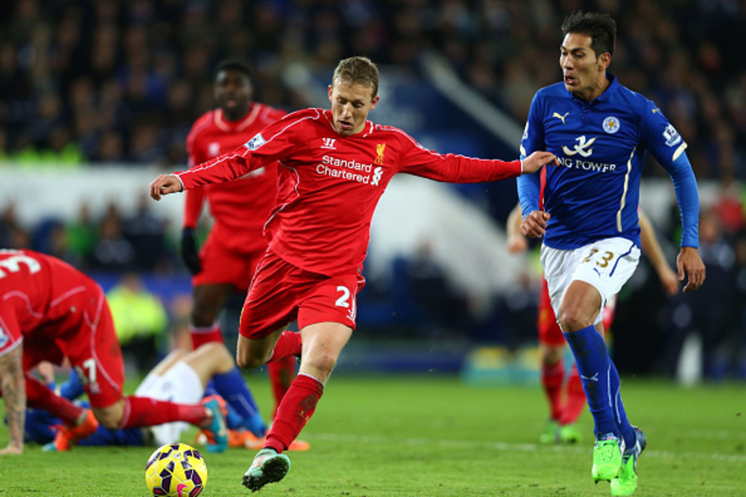 LEICESTER, ENGLAND - DECEMBER 02:  Lucas Leiva of Liverpool clears the ball as Leonardo Ulloa of Leicester City closes in during the Barclays Premier League match between Leicester City and Liverpool at The King Power Stadium on December 2, 2014 in Leices