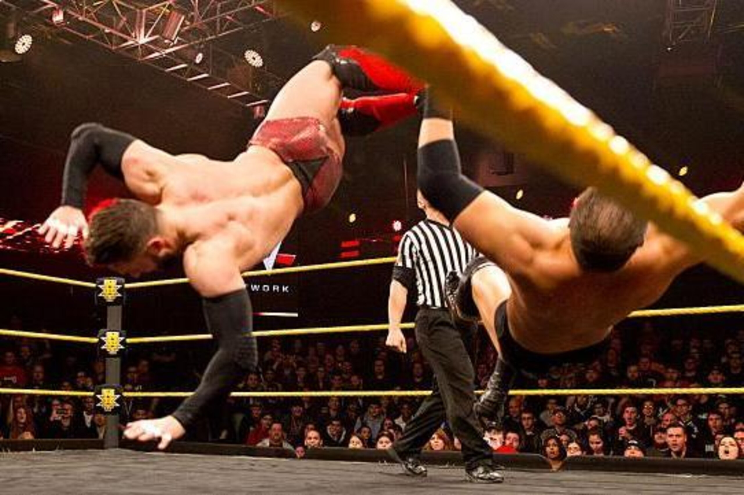 Finn Balor knocks Curtis Axel off his feet.